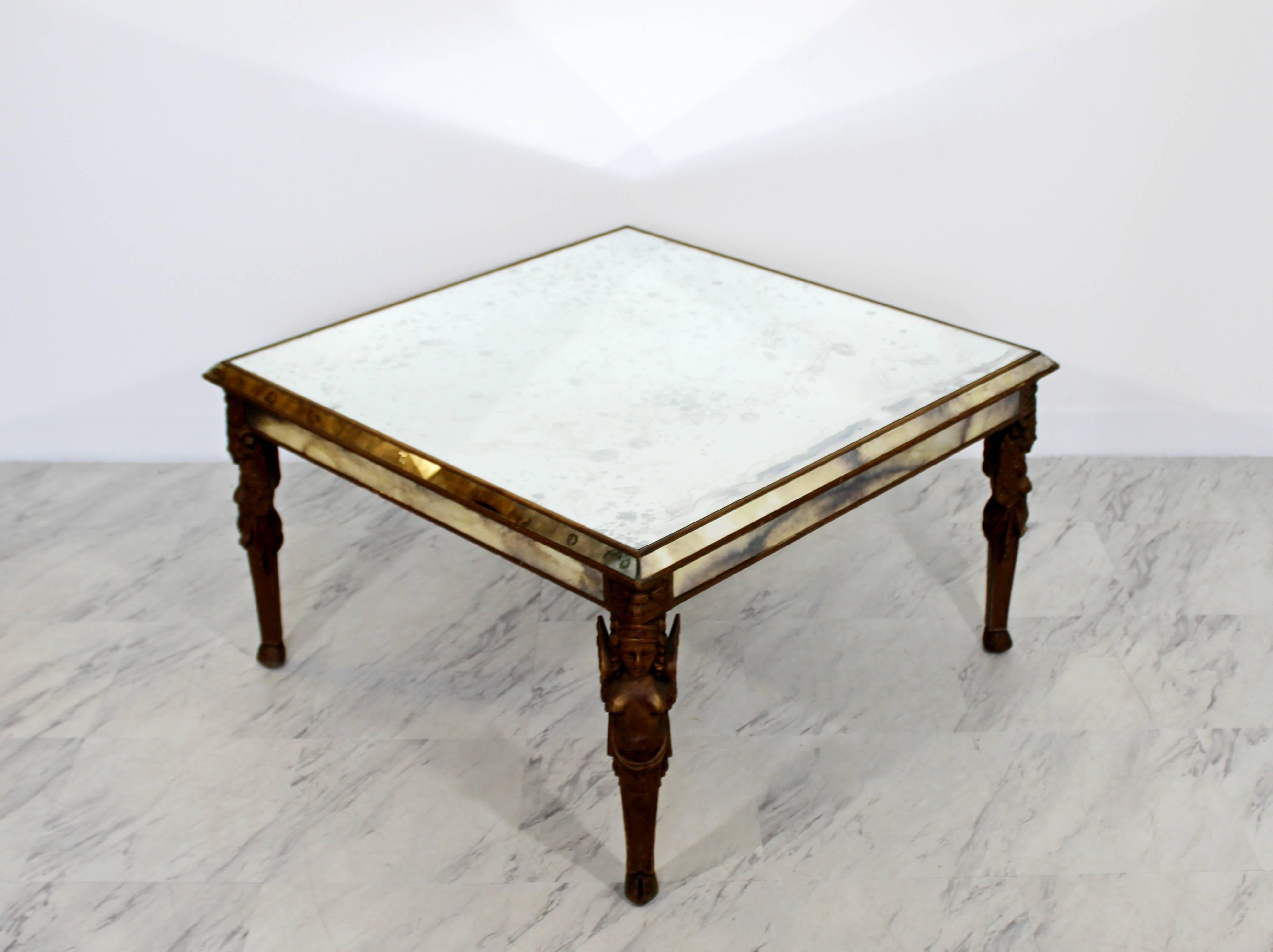 For your consideration is an intricately carved Art Deco wooden coffee table, with carved angels on the legs. Antique smoked mirrored glass top. In great condition. The dimensions are 32