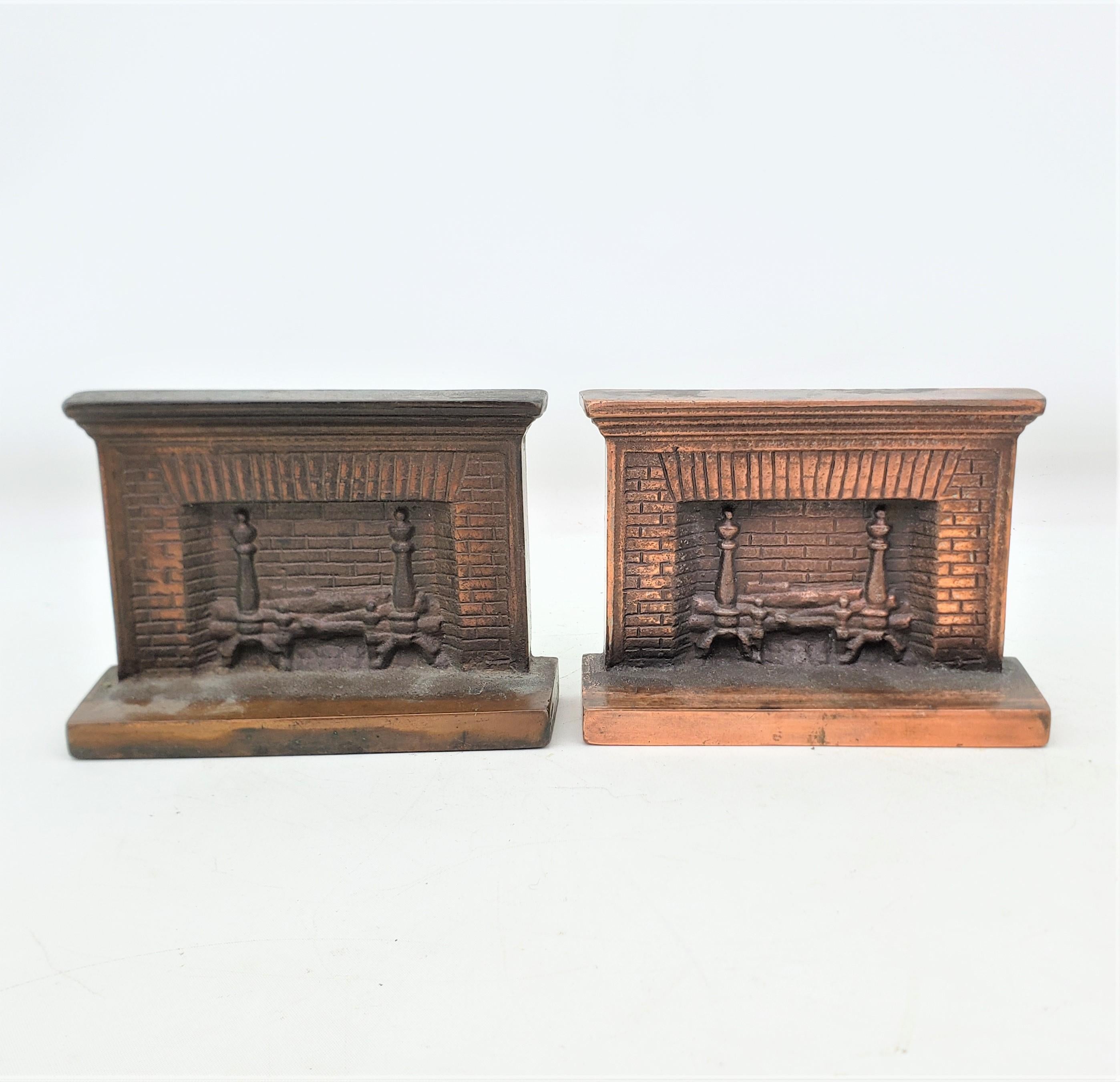 This large and heavy pair of antique bookends are unsigned, but presumed to have originated from the United States and date to approximately 1920 and done in the period Art Deco style. The bookends are composed of cast steel with a bronze patination