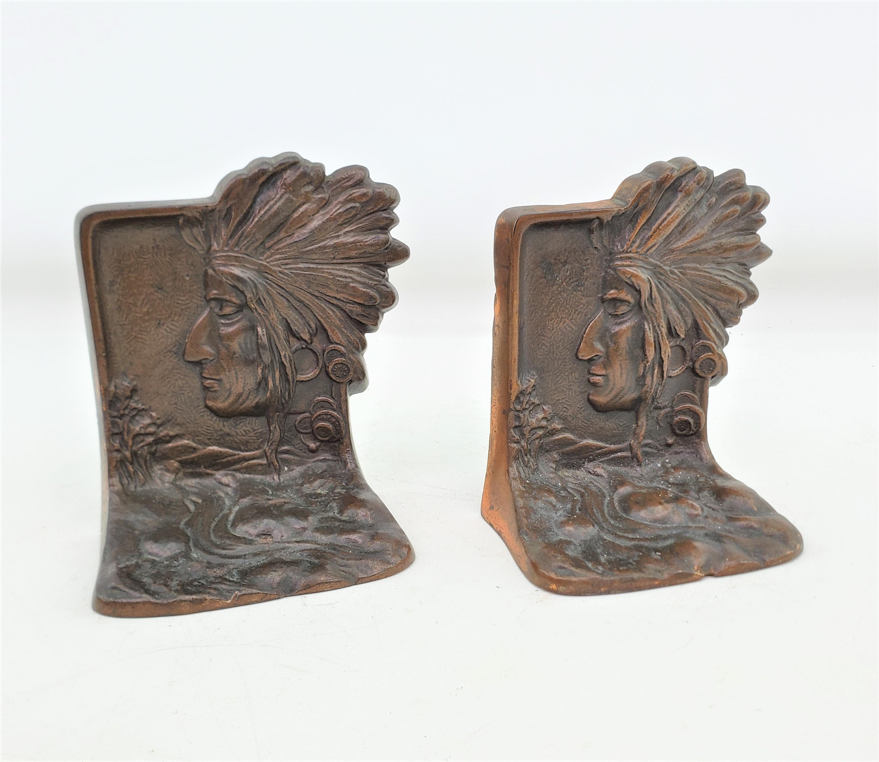 This pair of antique bookends are unsigned, but presumed to have originated from the United States and date to approximately 1920 and done in the period Art Deco style. The bookends are composed of cast steel with a bronze patination and depict the