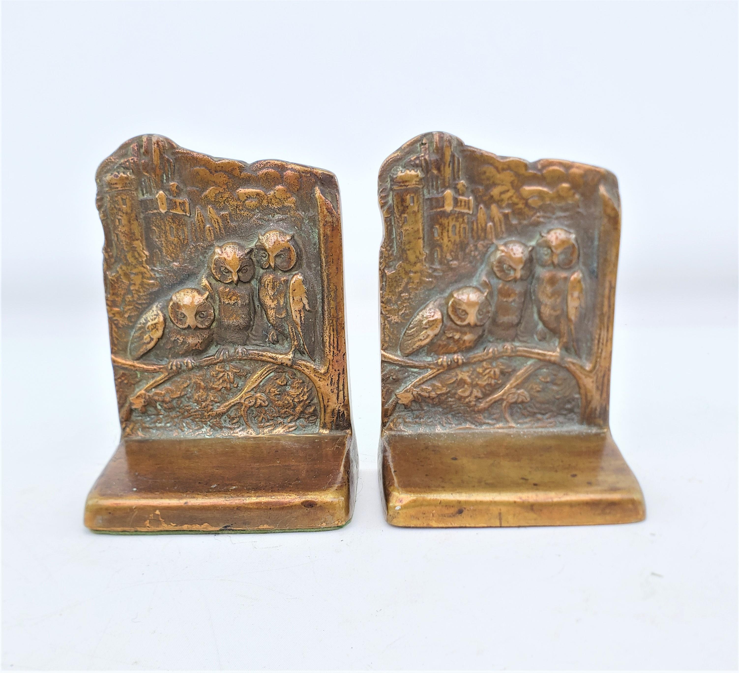 This pair of antique bookends are unsigned, but presumed to have originated from the United States and date to approximately 1920 and done in the period Art Deco style. The bookends are composed of cast brass with a lacquered finish and depict three