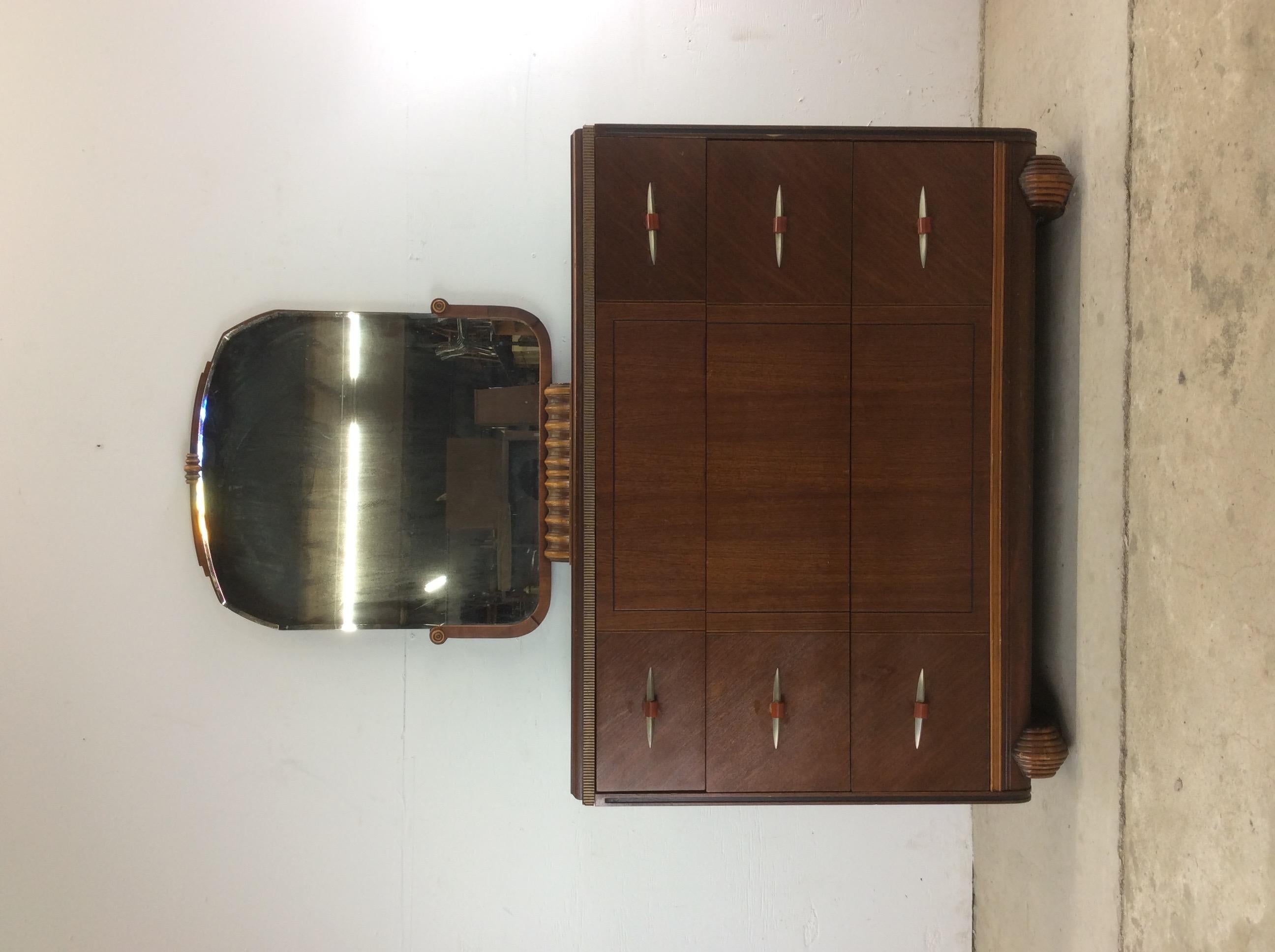 This beautiful antique chest of drawers features original finish, unique chrome & bakelite hardware, small removable mirror and carved feet.

Dimensions: 68” is to the top of the mirror. Dresser stands 34” high.

Matching mirrored vanity, highboy