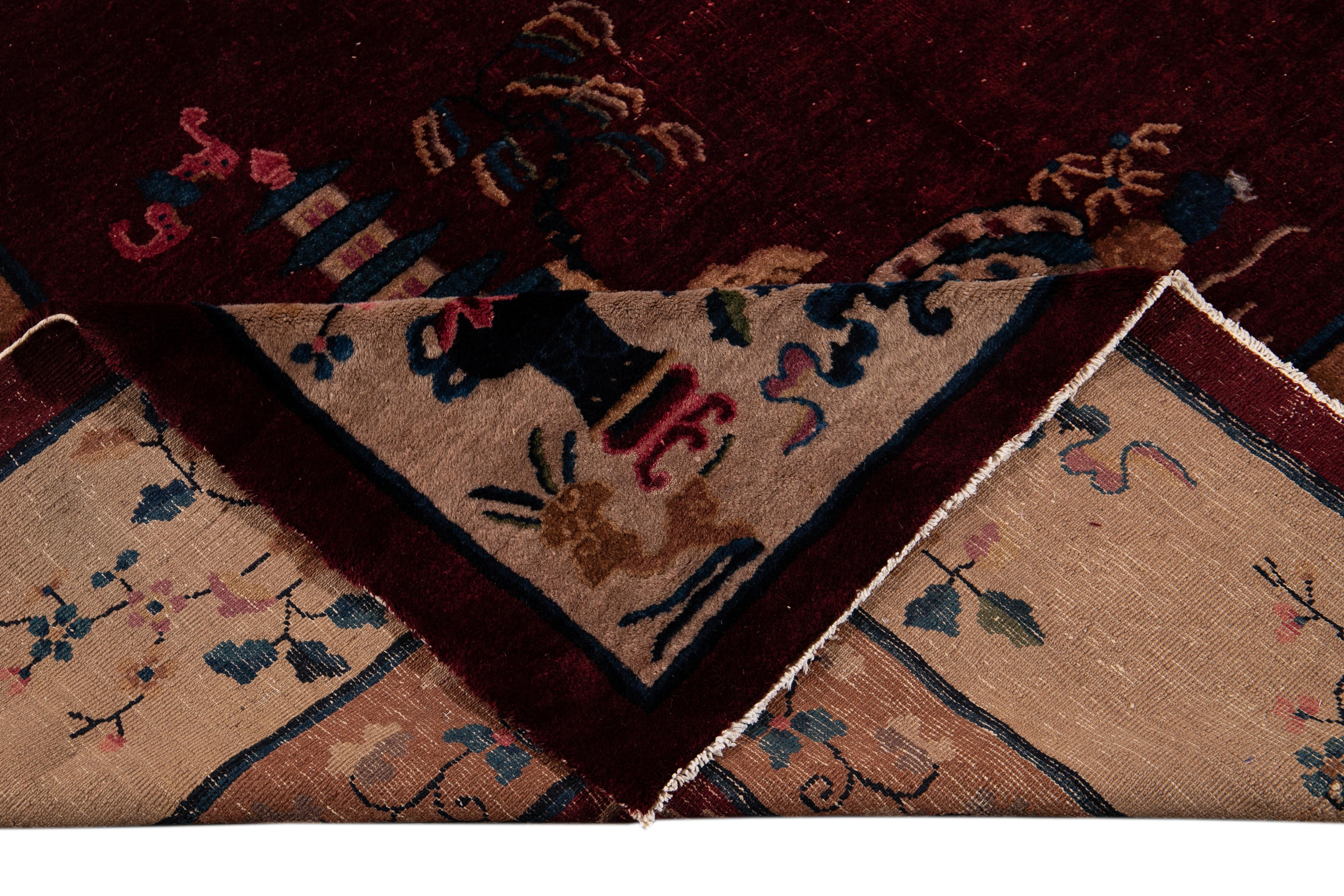 Beautiful Antique Chinese Art Deco Rug, hand-knotted wool with a wine red field, tan frame in an allover Classic Chinese floral design.

 This rug measures 12' x 14' 9