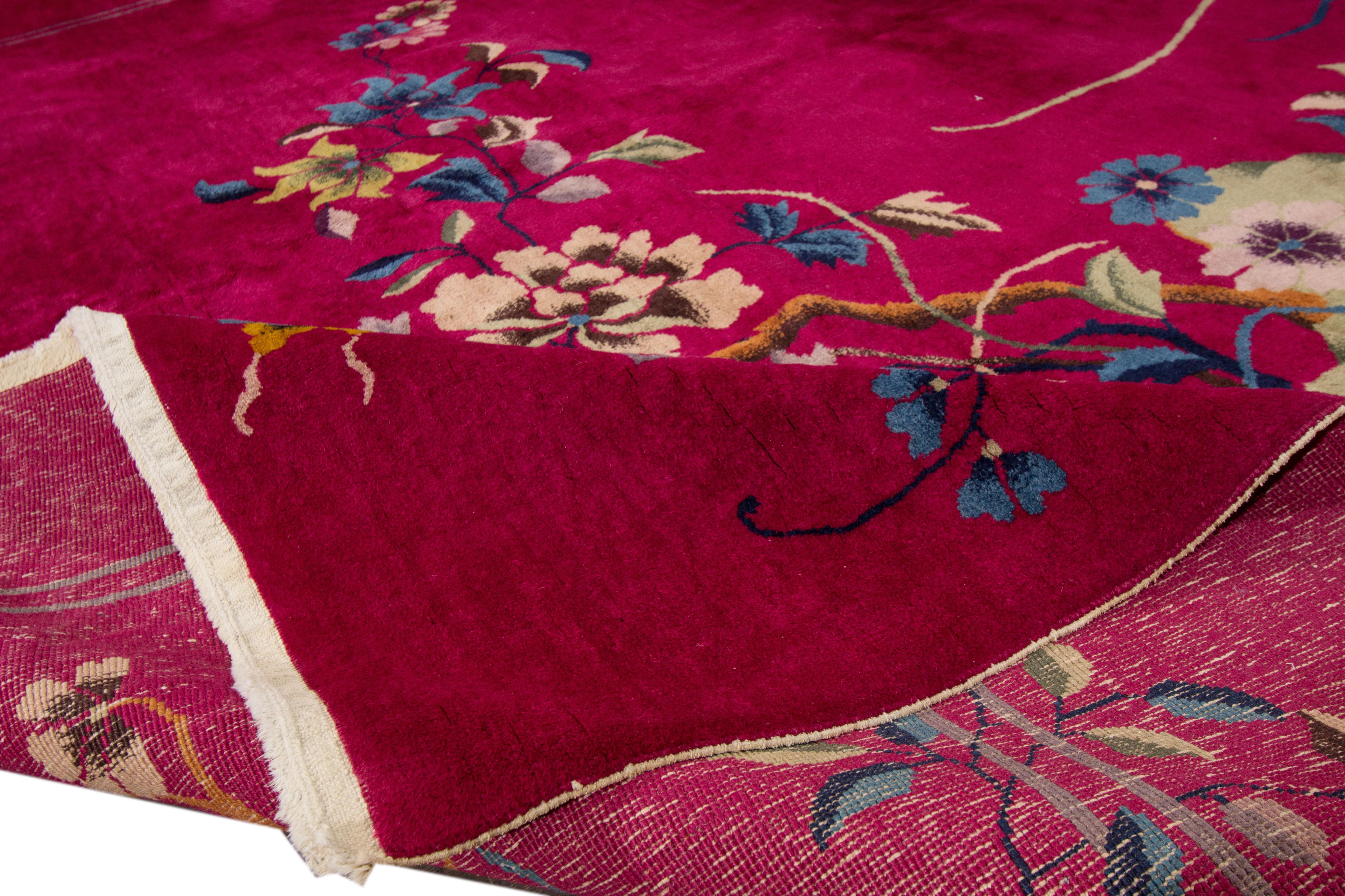 Beautiful antique Chinese Art Deco rug, hand knotted wool with a red field, and multi-color accents in an all-over Classic Chinese floral design, circa 1920.

 This rug measures 9' 2