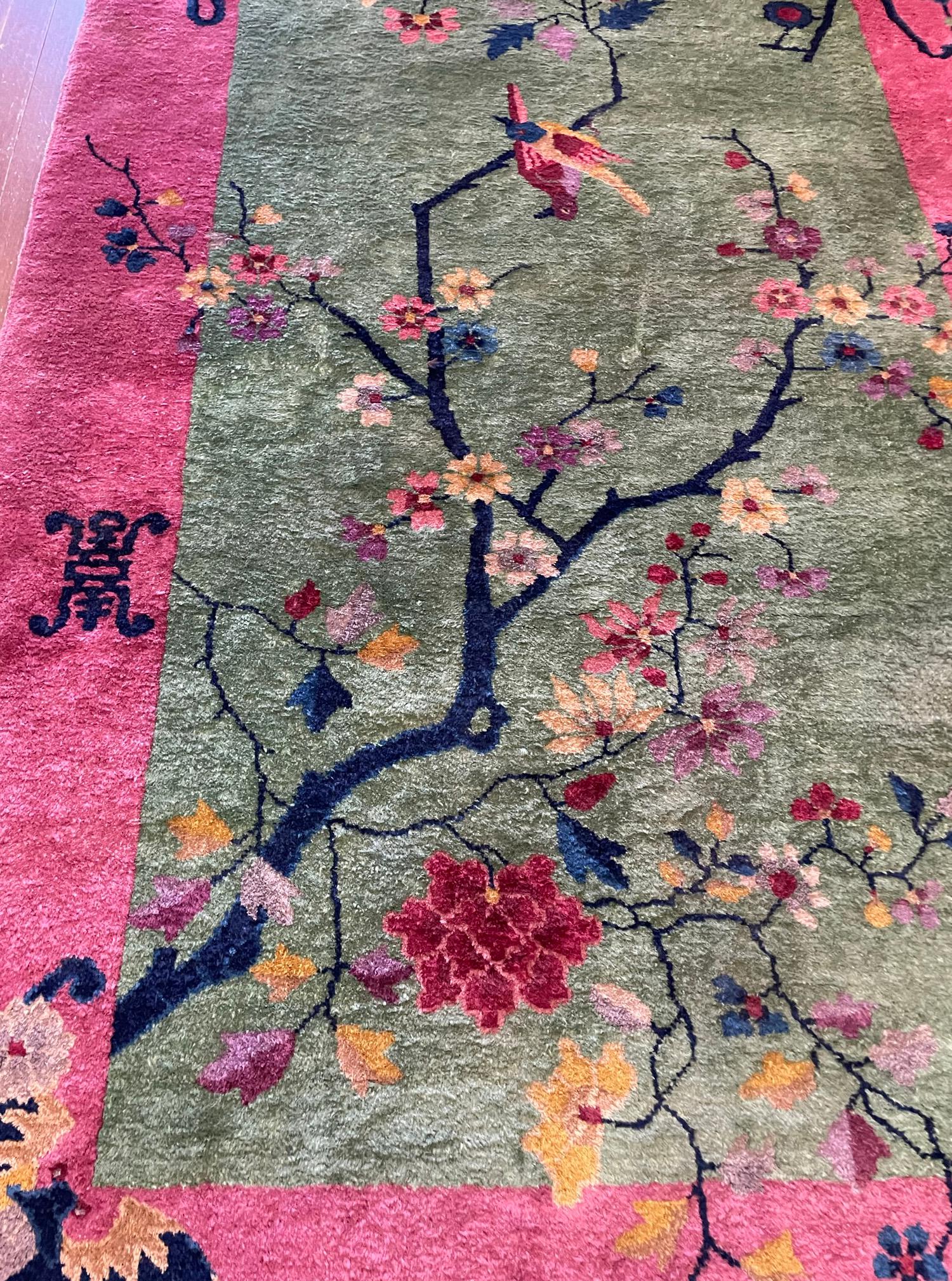 ﻿Introducing the first of our splendid pair, the Tree of Life Chinese rug, where artistry intertwines with symbolism. The enchanting jade green field hosts a majestic Tree of Life, where birds find sanctuary upon its branches, embracing the essence