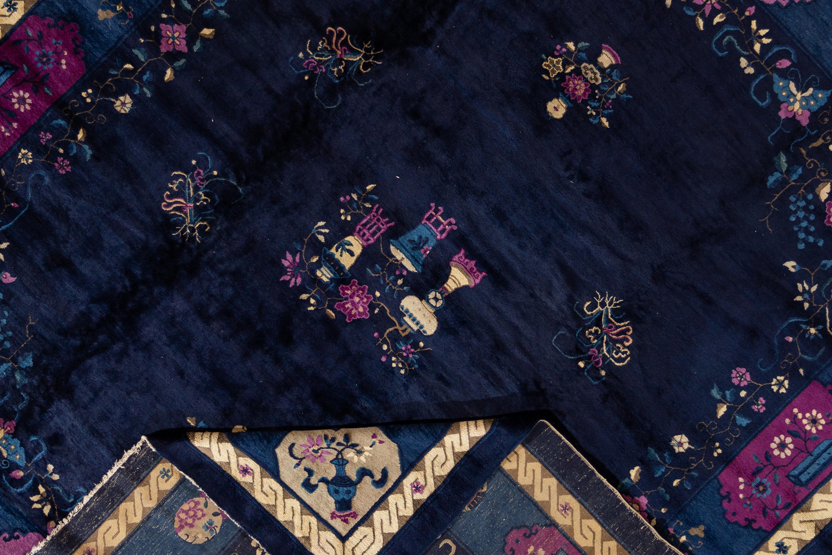 Beautiful Antique Chinese Art Deco hand-knotted wool Rug, with an indigo field,  in an allover Classic Chinese floral design.

This rug measures 10'8