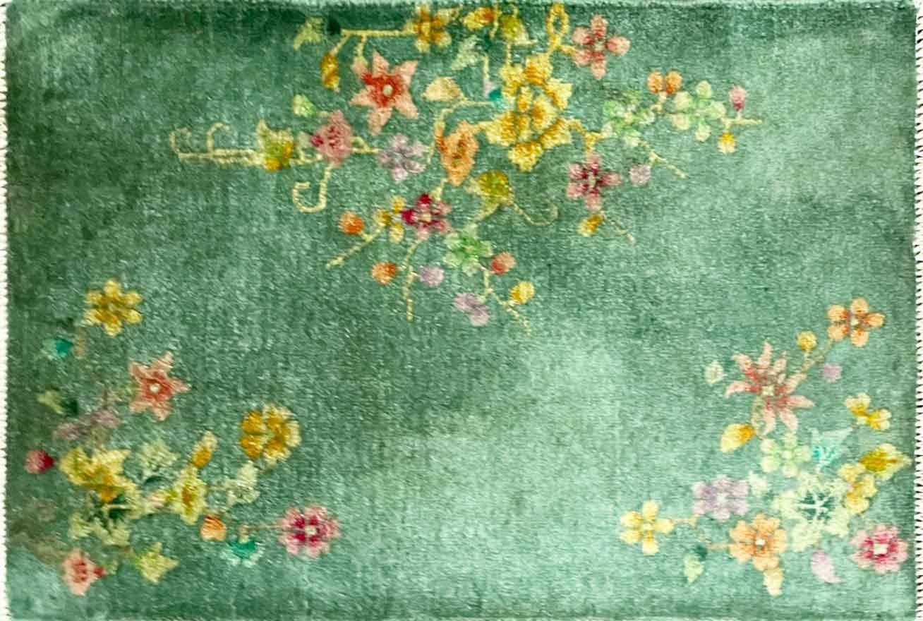 Handmade Antique Art Deco floral Chinese Rug, 2' x 3' , c-1920's, in green color background with floral traditional design on each corner of the rug. The rug is in good condition and has been professionally cleaned. This wonderful Art Deco carpet