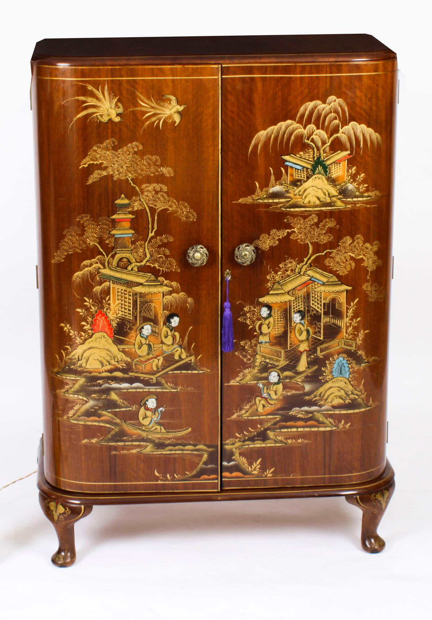 This is a fantastic antique Art Deco walnut cocktail cabinet with Chinoiserie lacquered decoration by Frank Hudson & Sons for Harrods,  circa 1920 in date.
 
The fitted twin doors opens to reveal a mirrored interior decorated with three shelves and