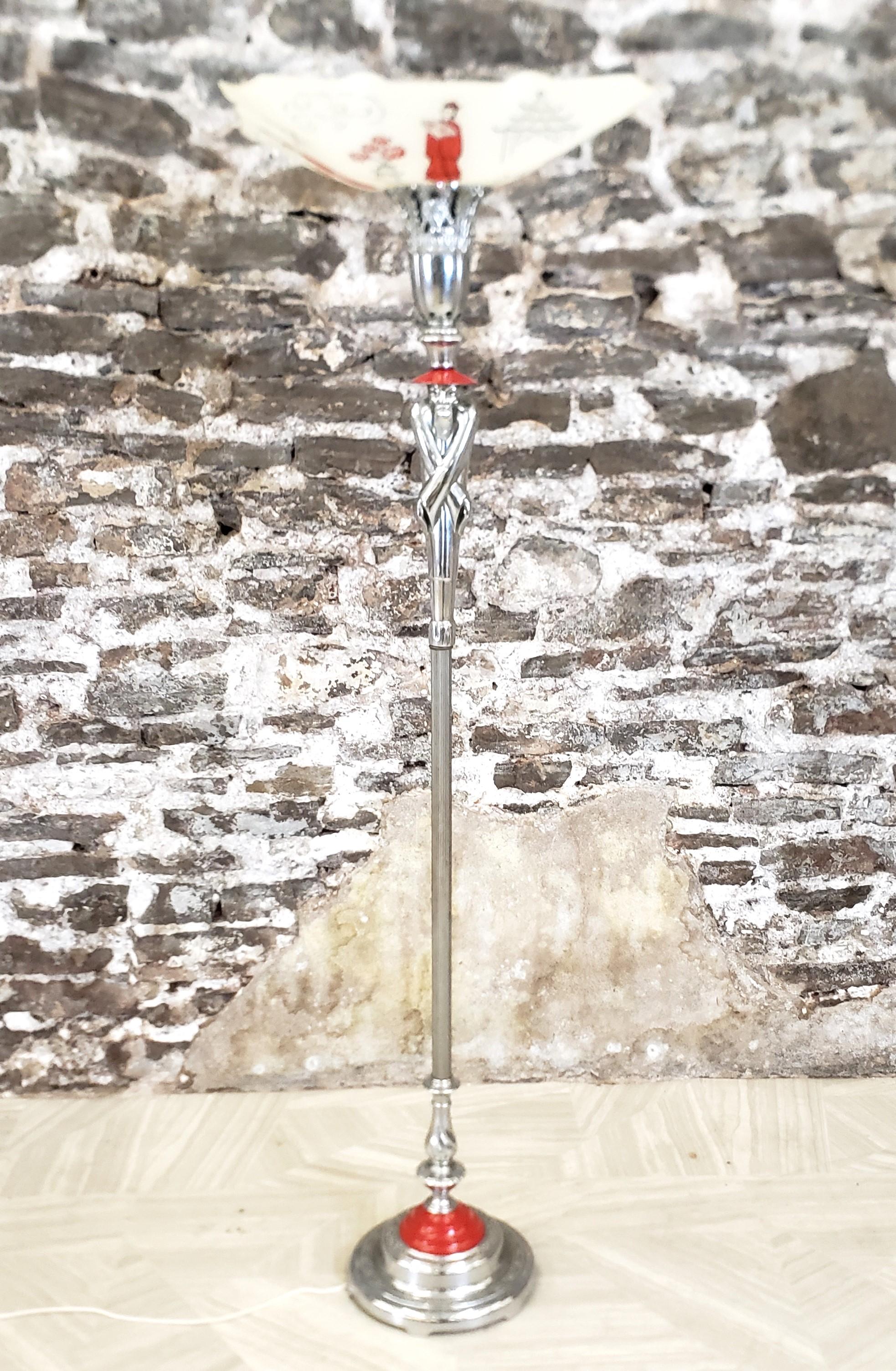 This antique torchiere floor lamp is unsigned with respect to the maker, but presumed to have originated from the United States and date to approximately 1920 and done in the period Art Deco style. The lamp base is composed of chromed metal and