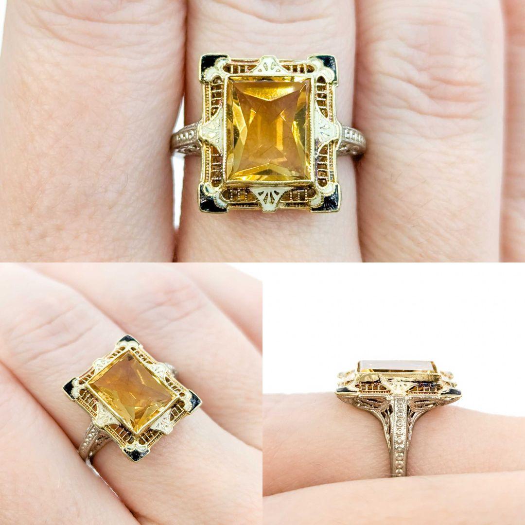 Antique Art Deco Citrine Filigree Ring with Enamel in White & Yellow Gold

Introducing this stunning Art Deco Ring crafted in 14k white & yellow gold, featuring a vibrant 3.10ct citrine gemstone with delicate enamel detailing in cream and black.