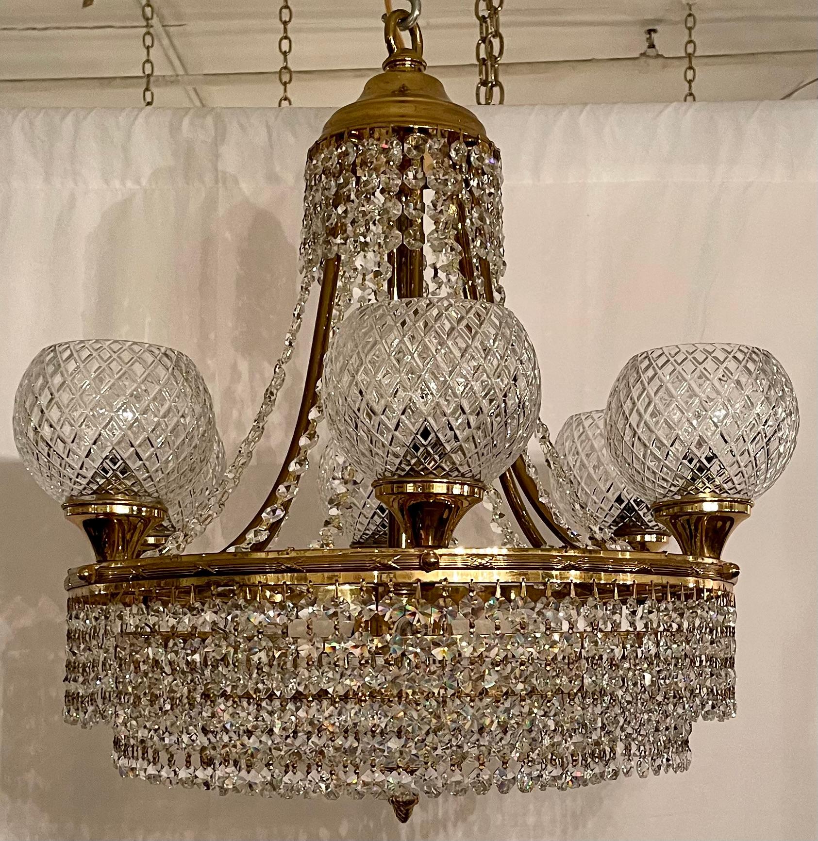 Antique Art Deco Cut Crystal and Gold Bronze Chandelier, Circa 1940.
Per the last photo, we have two of these chandeliers available and they can be sold as a pair.