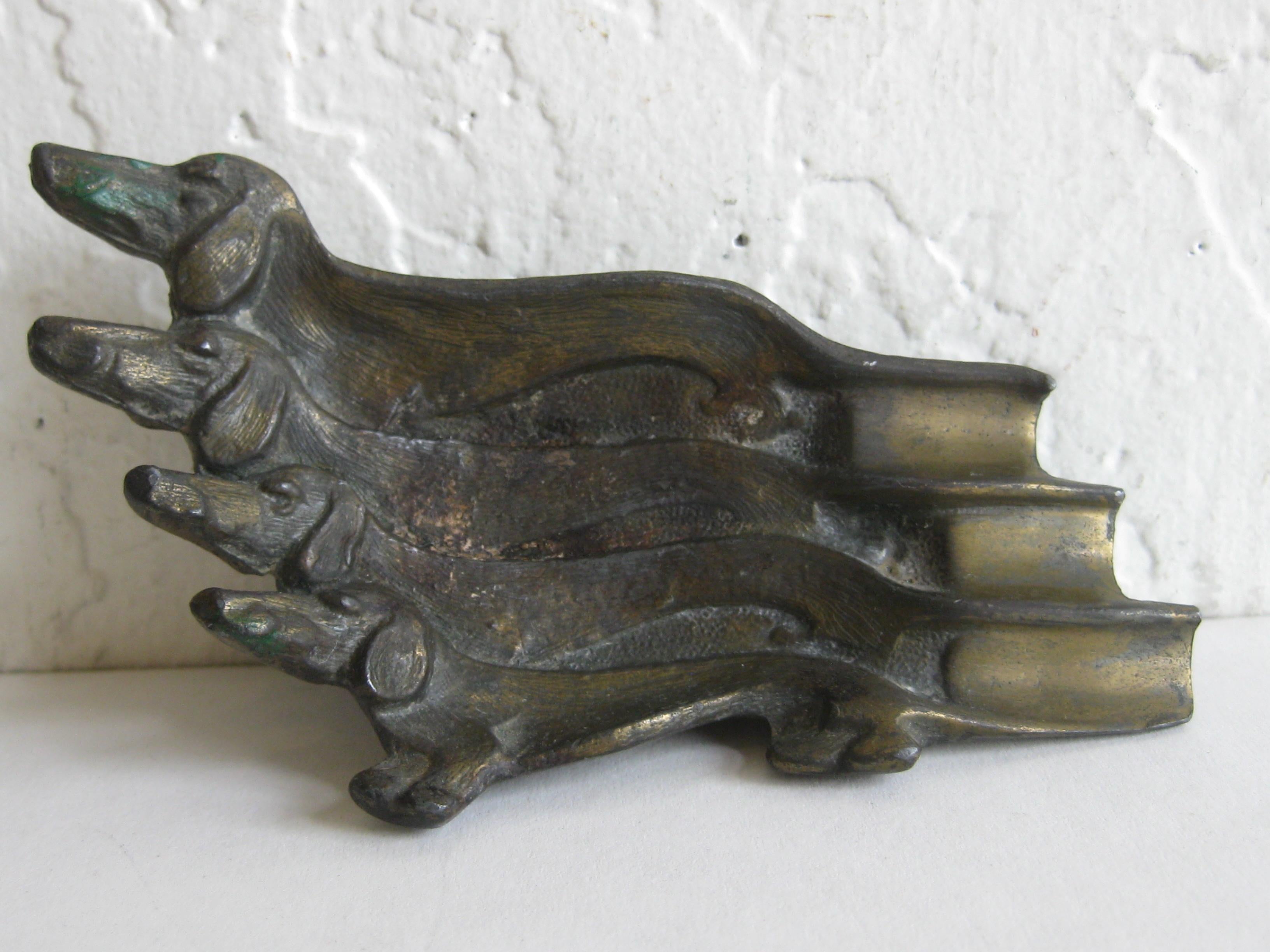 Great Art Deco figural dachshund dog ashtray. Made of cast metal and has a bronze finish. In very nice original condition with some patina. No broken parts, no cracks and no repairs. Measures 4 1/2
