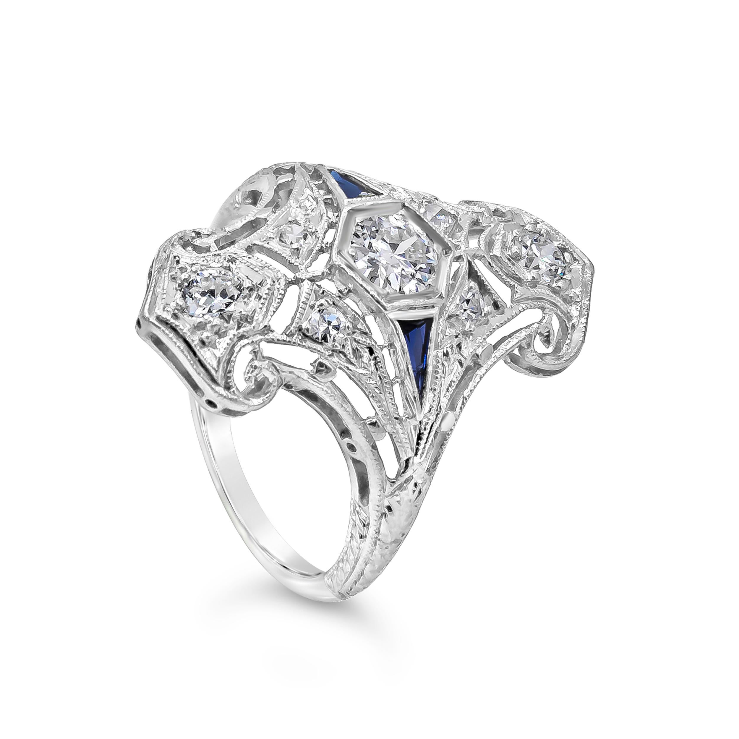 A gorgeous antique ring showcasing round brilliant diamonds and two trillion blue sapphires set in an intricately designed ring. Hand-carved. Diamonds weigh 0.42 carats total. Size 5 US.