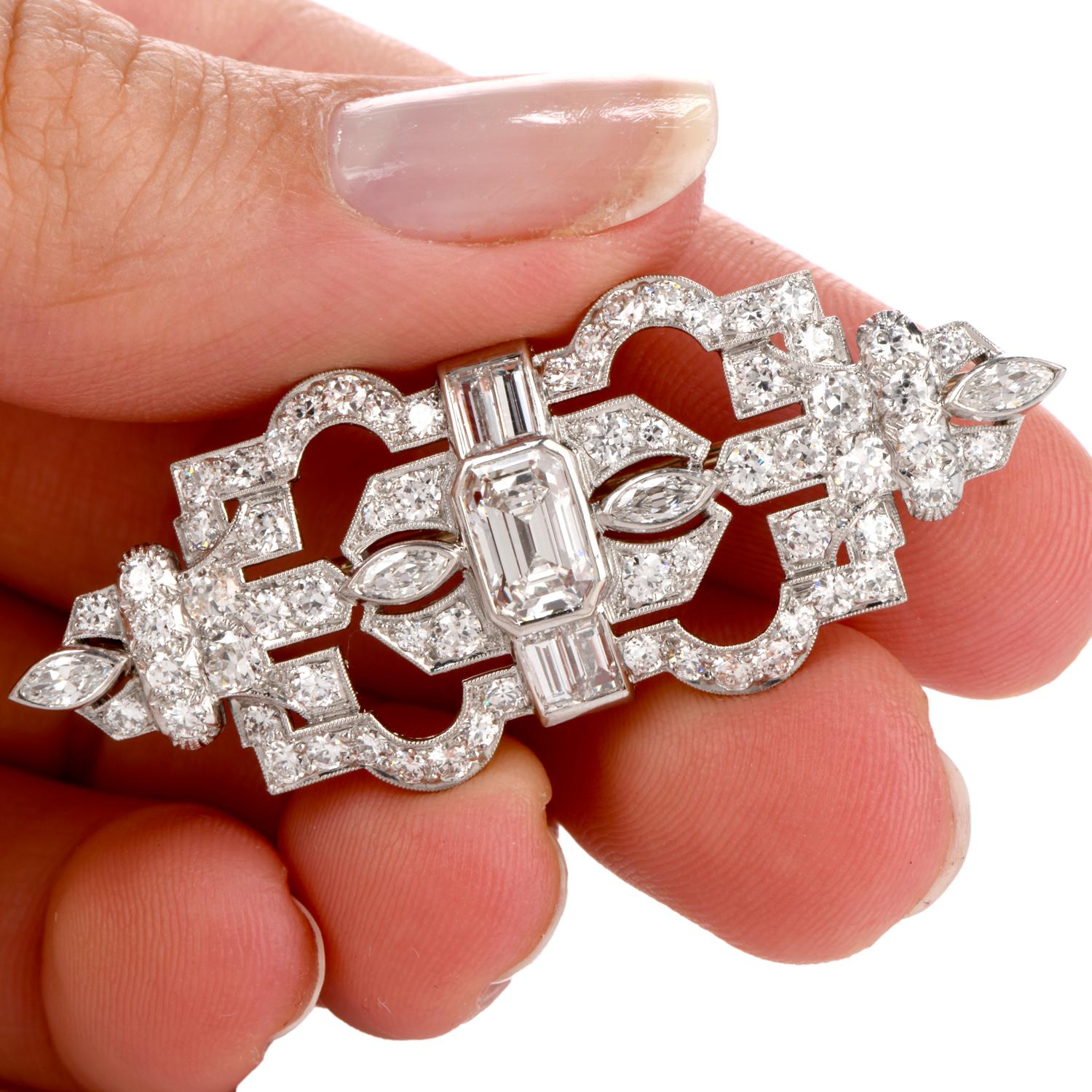 This stately art deco Emerald Cut Diamond Centered Brooch offers a feel of

Royalty as the 2 crowns join in the center. Prominently featured are an Emerald cut weighing approx. 1.48 carats G-H Vs1-VS2 clarity. and 4 large Baguette cut Diamonds