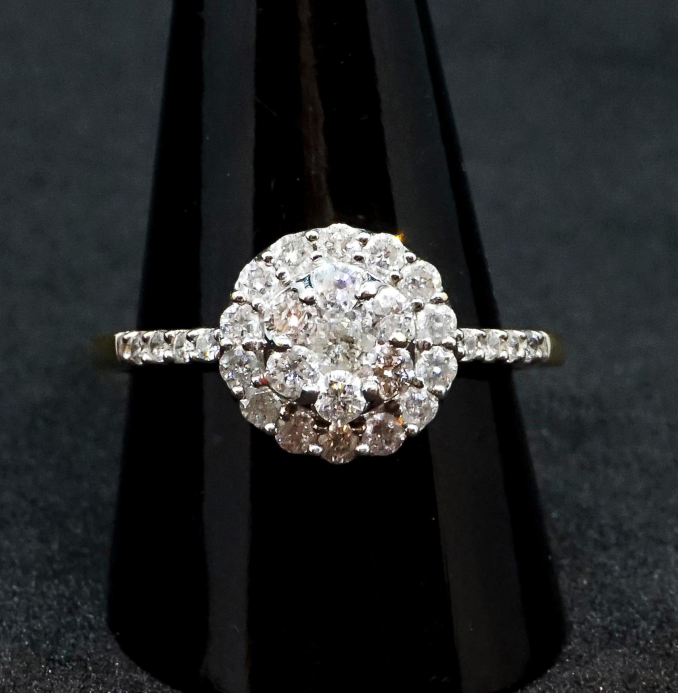 Antique flower-shaped old brilliant-cut diamond ring:
seven old brilliant-cut diamonds centered in a cluster, surounded by a halo of fourteen diamonds, another four diamonds in each of the shoulders, all diamonds estimated to weigh a total of 1.0