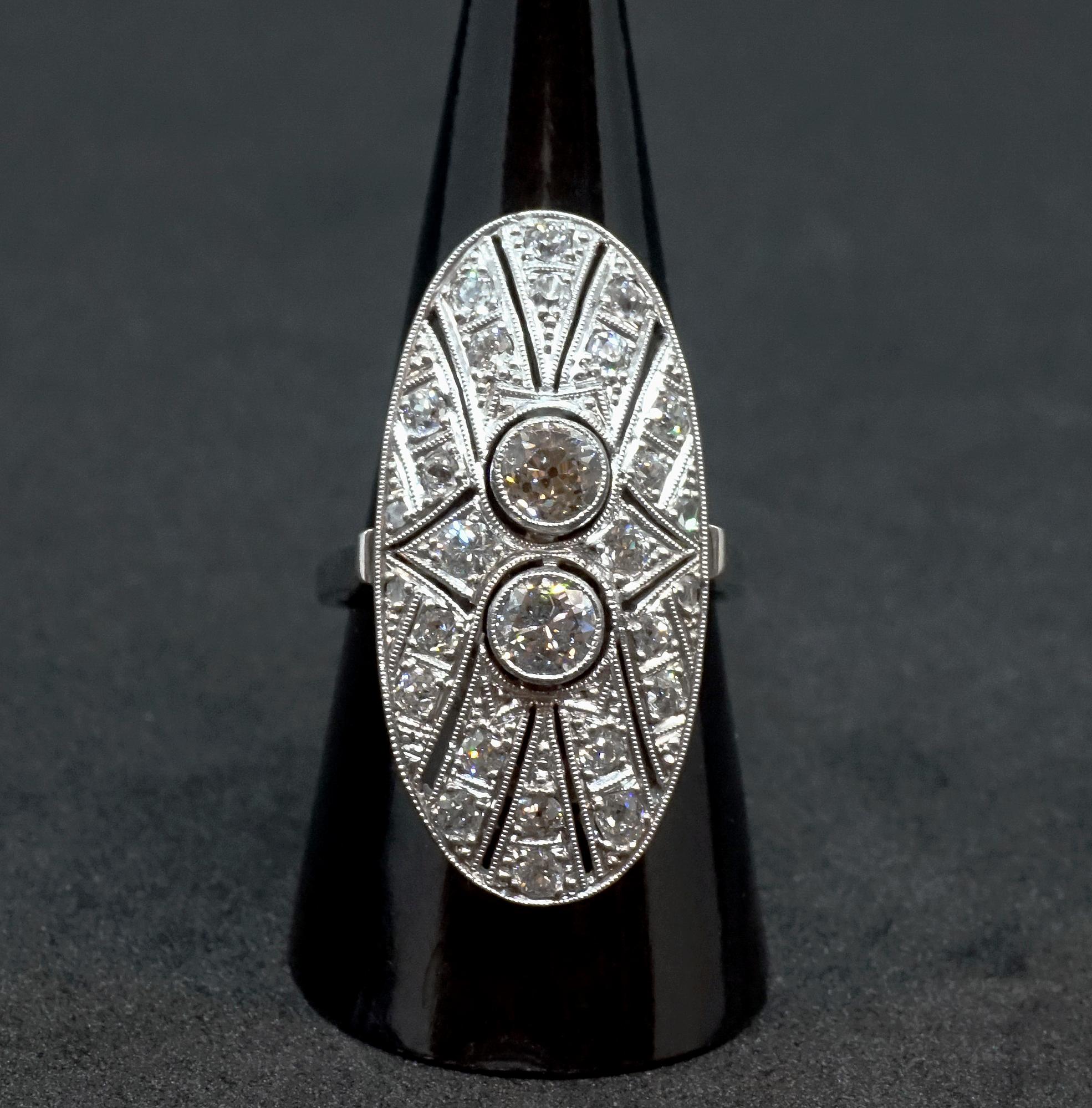 Delicate antique navette-shaped old brilliant-cut diamond ring, with two centered old cut diamonds estimated 0.3 carat each set in a row, surounded by further small diamonds set in radial rows in a millegrain openwork collet, all diamonds together