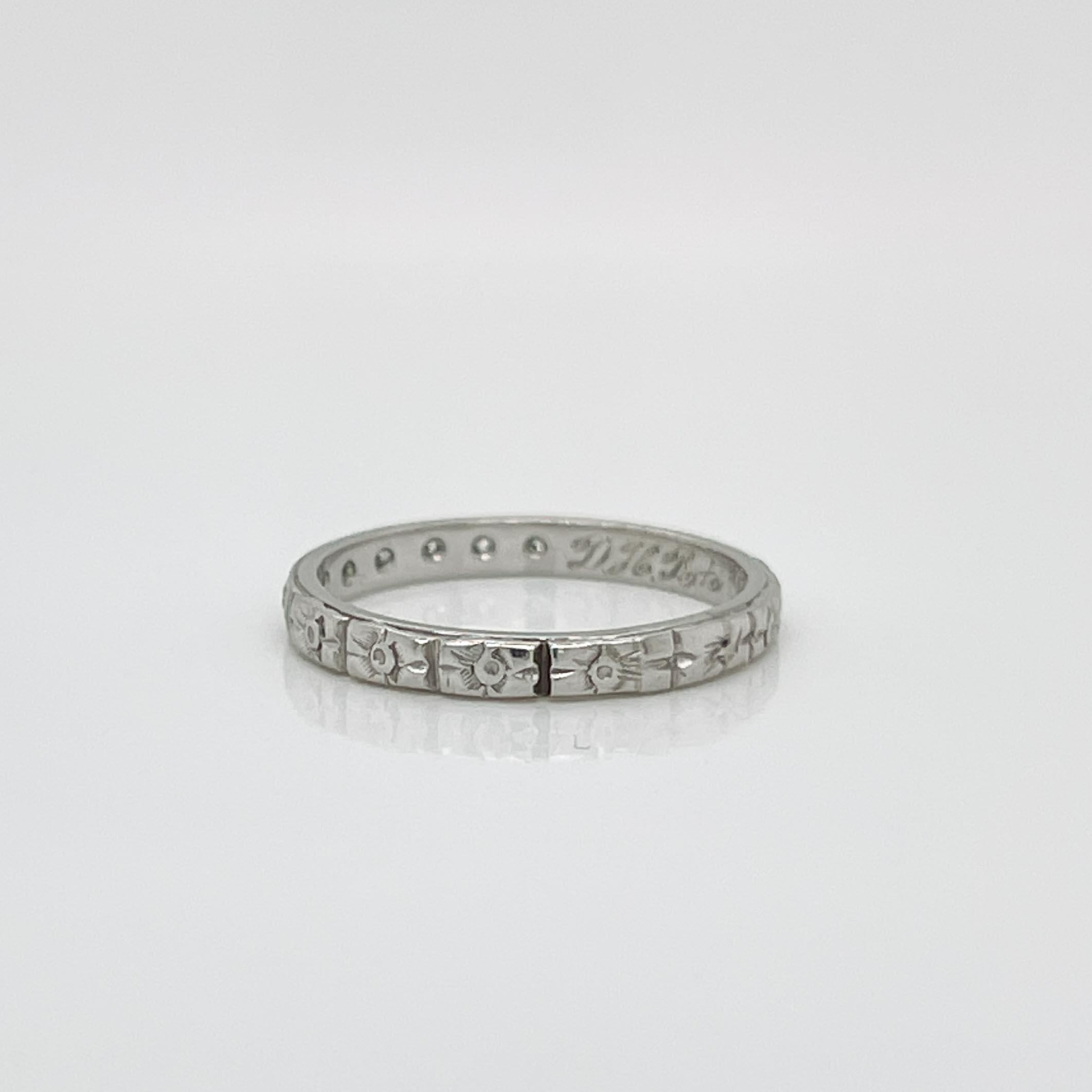 A fine Art Deco period band ring.

In platinum.

Prong set with 7 small round cut white diamonds and engraved with orange blossom decoration around the band.

Simply a wonderful period ring!

Date:
Early 20th Century

Overall Condition:
It is in