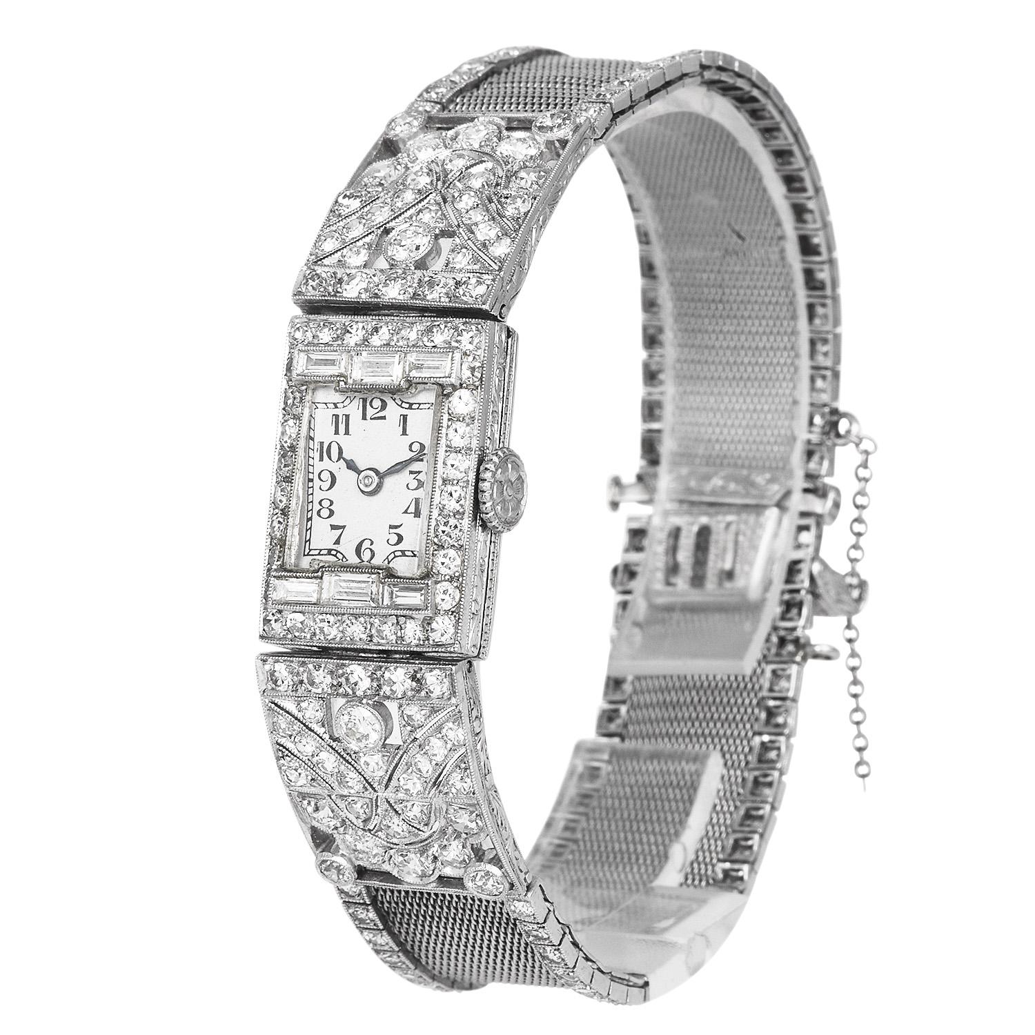 This Exquisite antique Diamond deco watch was inspired by a Geometrical & mesh design, and crafted in luxurious Platinum.

This Statement Piece will complement any evening attire.

Sparkling all over the piece are 186 Old Round Cut & (6)
