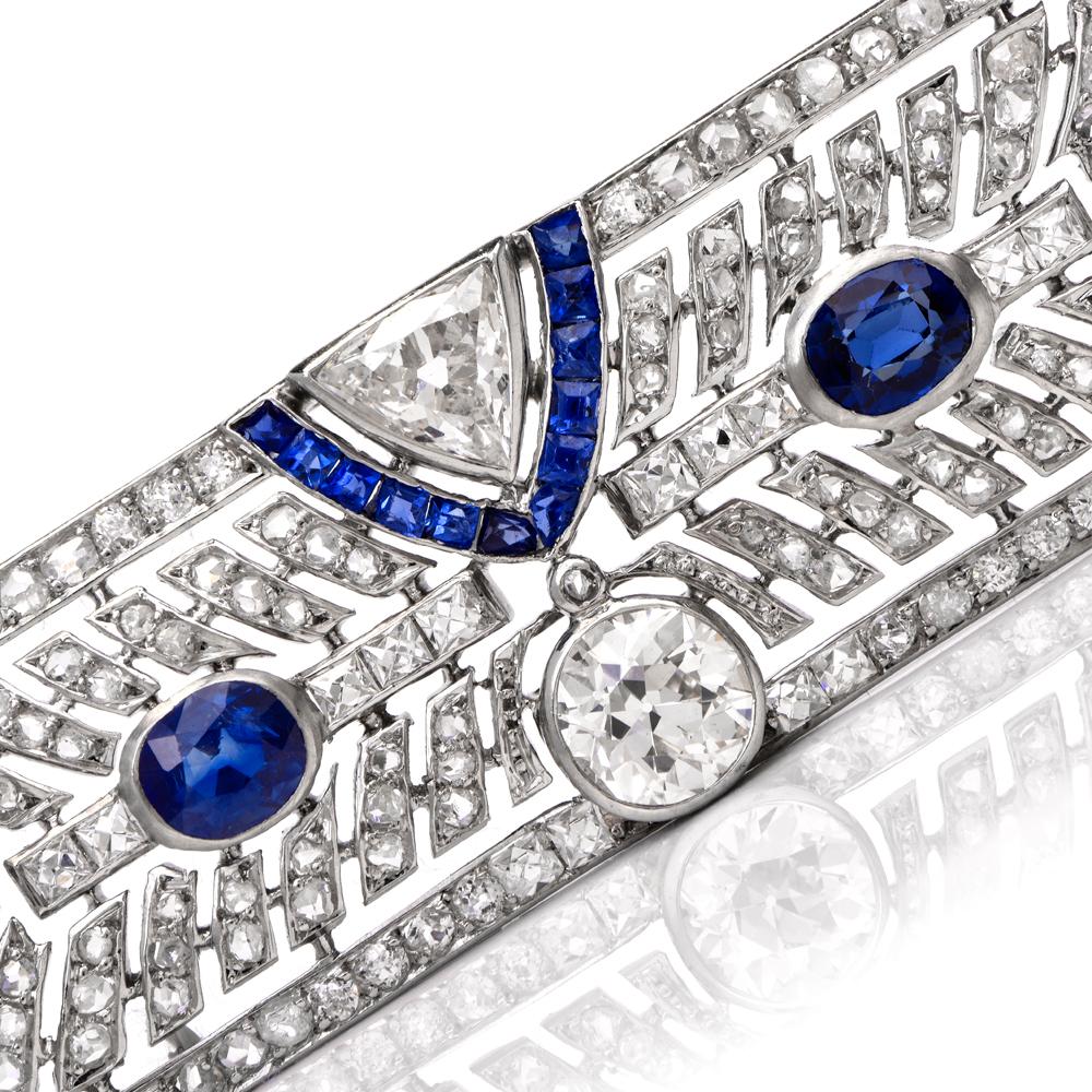 This timeless antique diamond and sapphire pin brooch is crafted in solid platinum. Displaying of geometric art deco patterns set in round-cut, square-cut, and triangular-cut diamonds weighing approx. 3.50 carats, graded H-I color, and VS2-SI