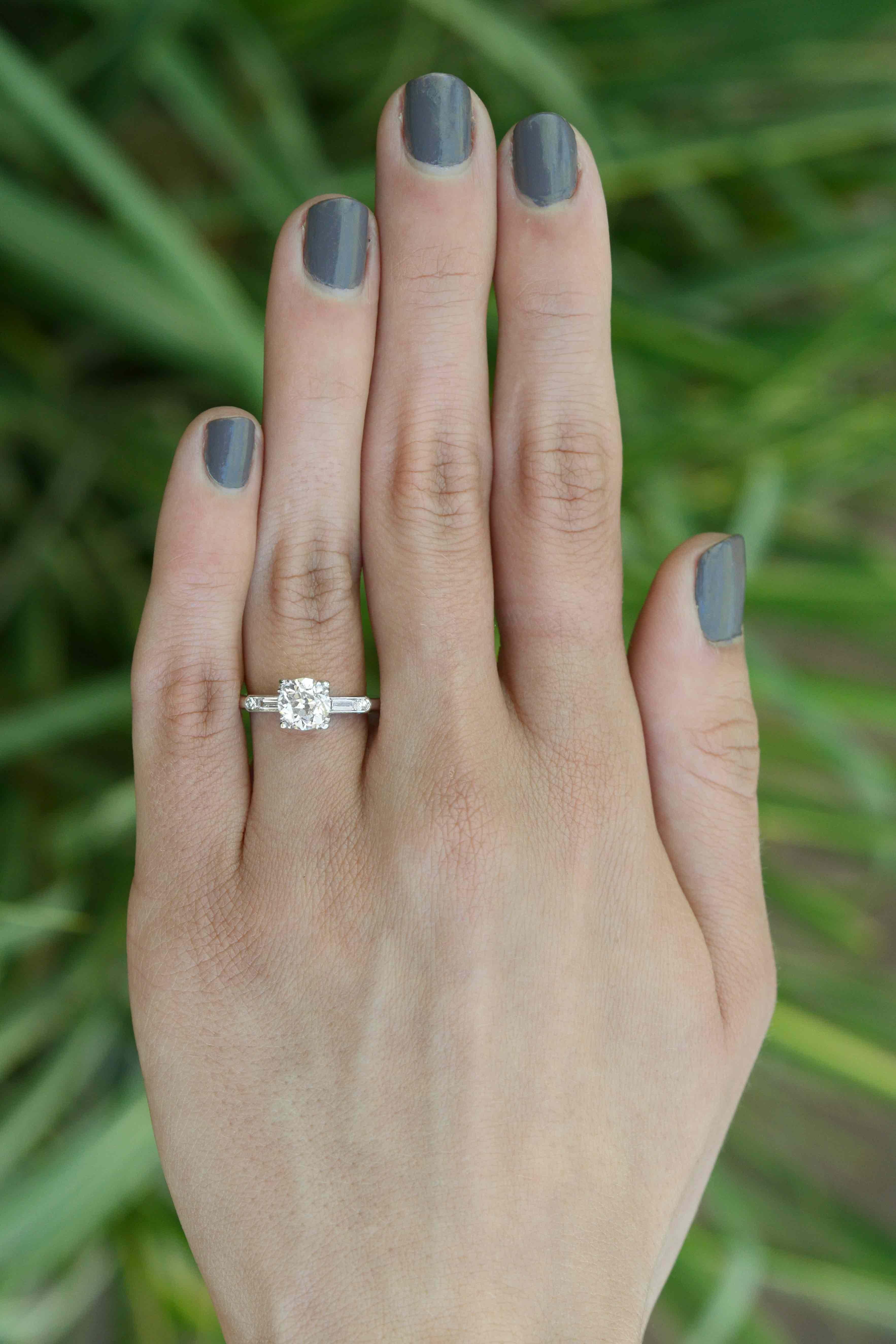 The Colorado Art Deco diamond solitaire is a stunning engagement ring. The classic, streamlined platinum setting is simple and elegant, embraced by an icy baguette and round sparkler on it's shoulders. A gorgeous chunk weighing 1.31 carats, the