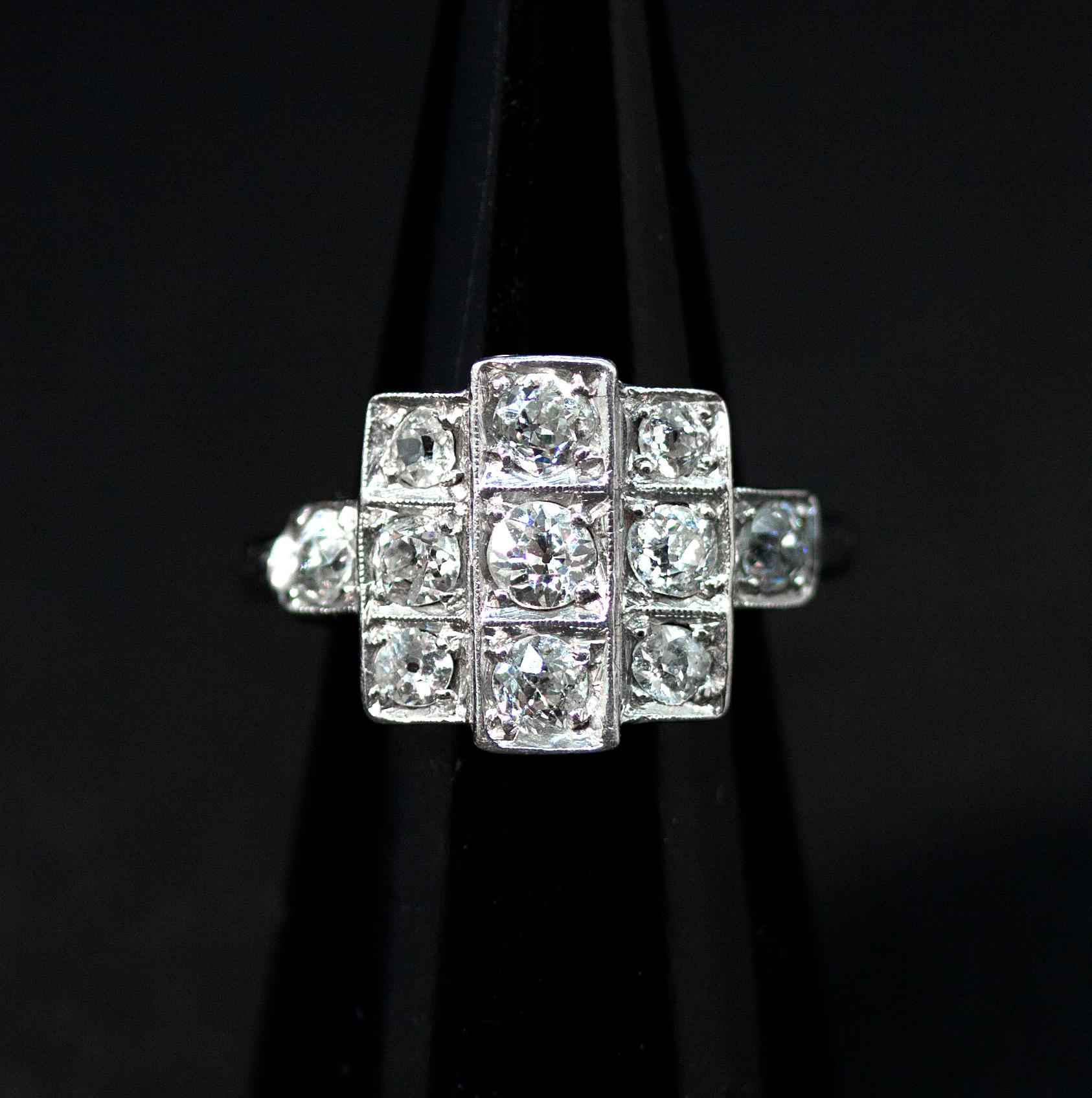 Antique brilliant cut old diamond ring:
Nine brilliant cut diamonds centered in a square cluster with overhanging center row flanked by two further brilliant cut diamonds on the shoulders, all diamonds have an estimated total weight of 1.3 carats,