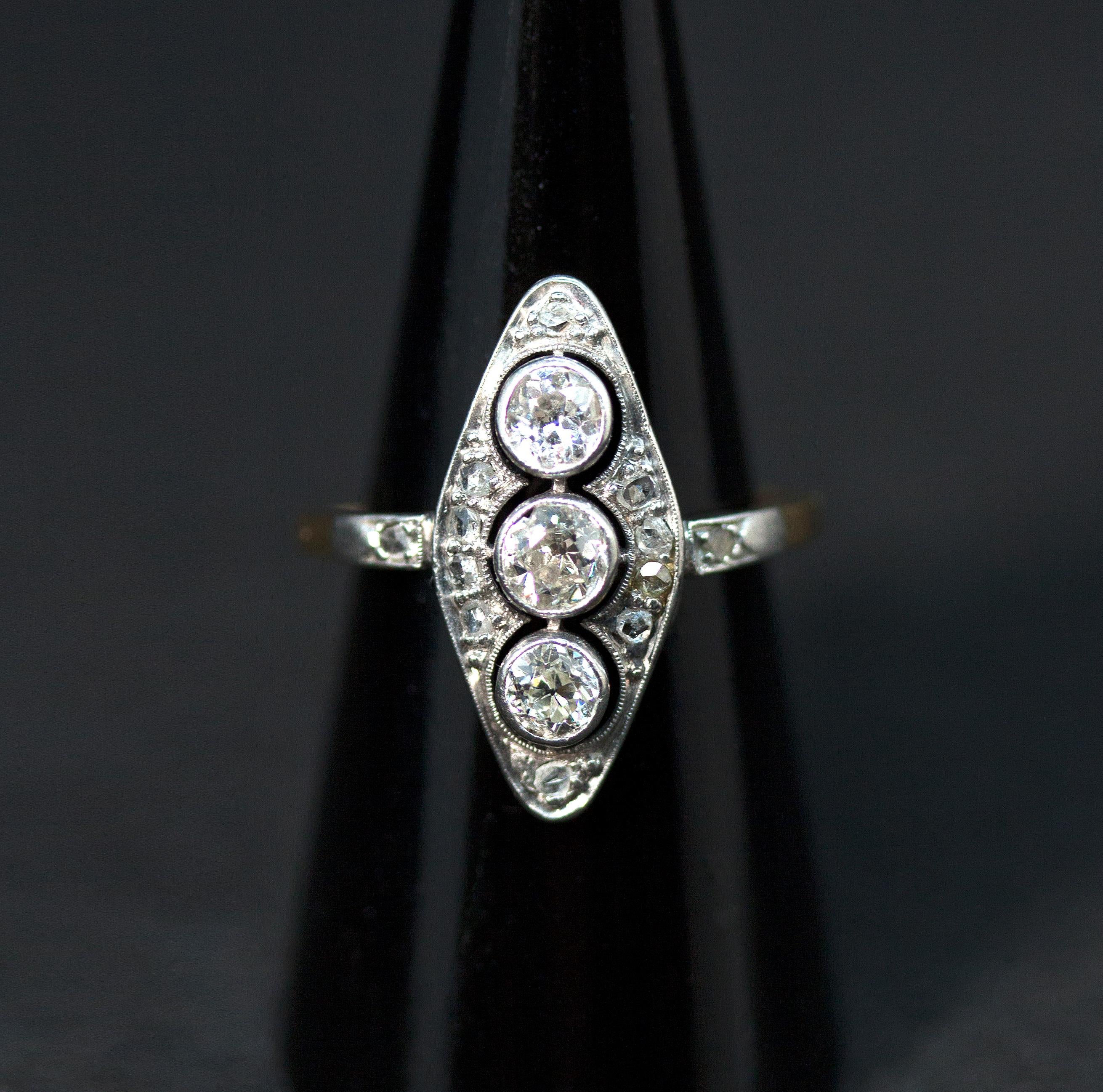 Delicate antique diamond-shaped old brilliant-cut diamond ring, with three old cut diamonds centered in a row estimated 0.25 carat each, surounded by further small diamonds in a millegrain openwork collet, two small stones on the shoulders flanking