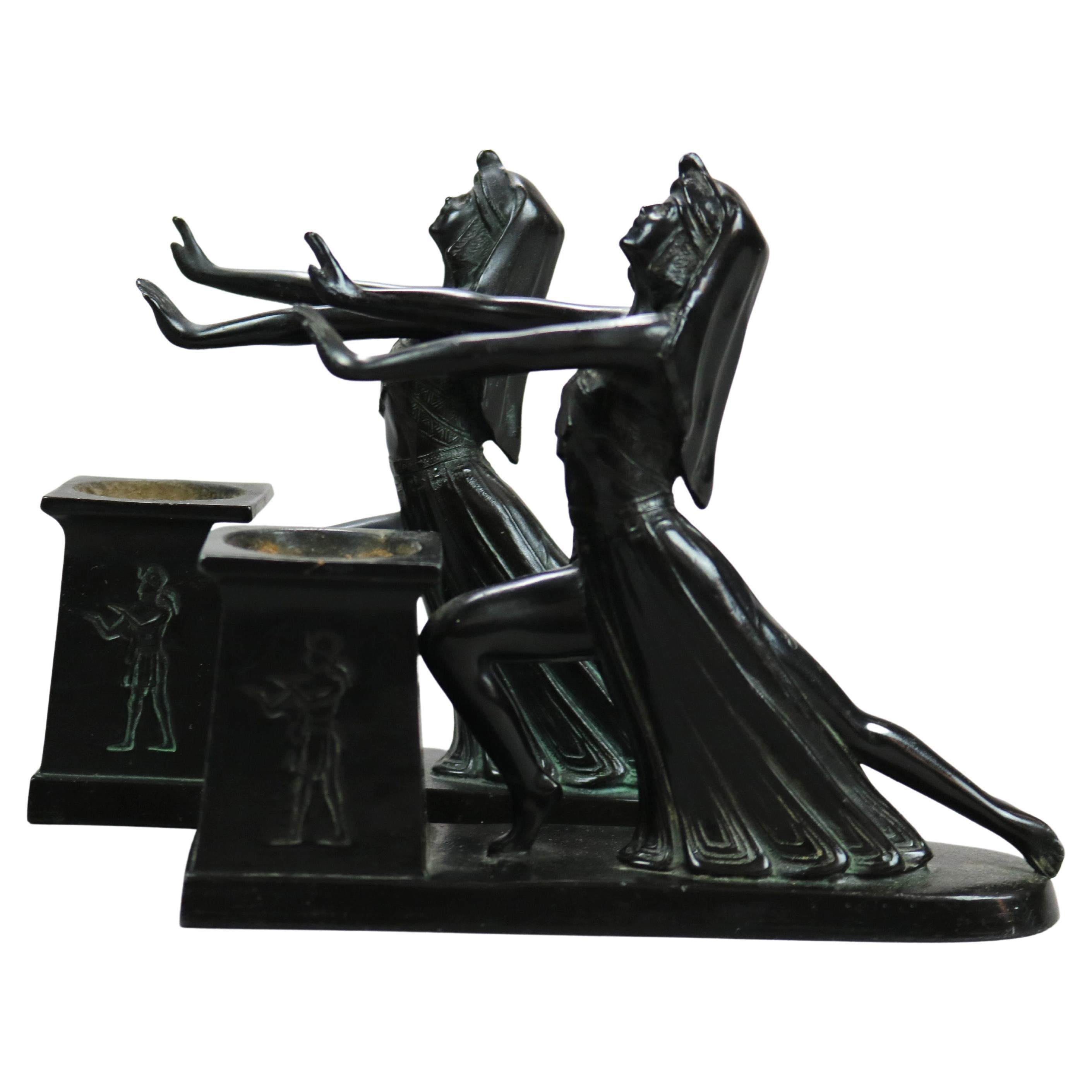 An antique pair of Art Deco incense burners by LV Aronson offer ebonized cast metal Egyptian female figures over burner plinth, signed and dated on base as photographed, 1924

Measures - 6.25''H X 2''W X 7.25''D.