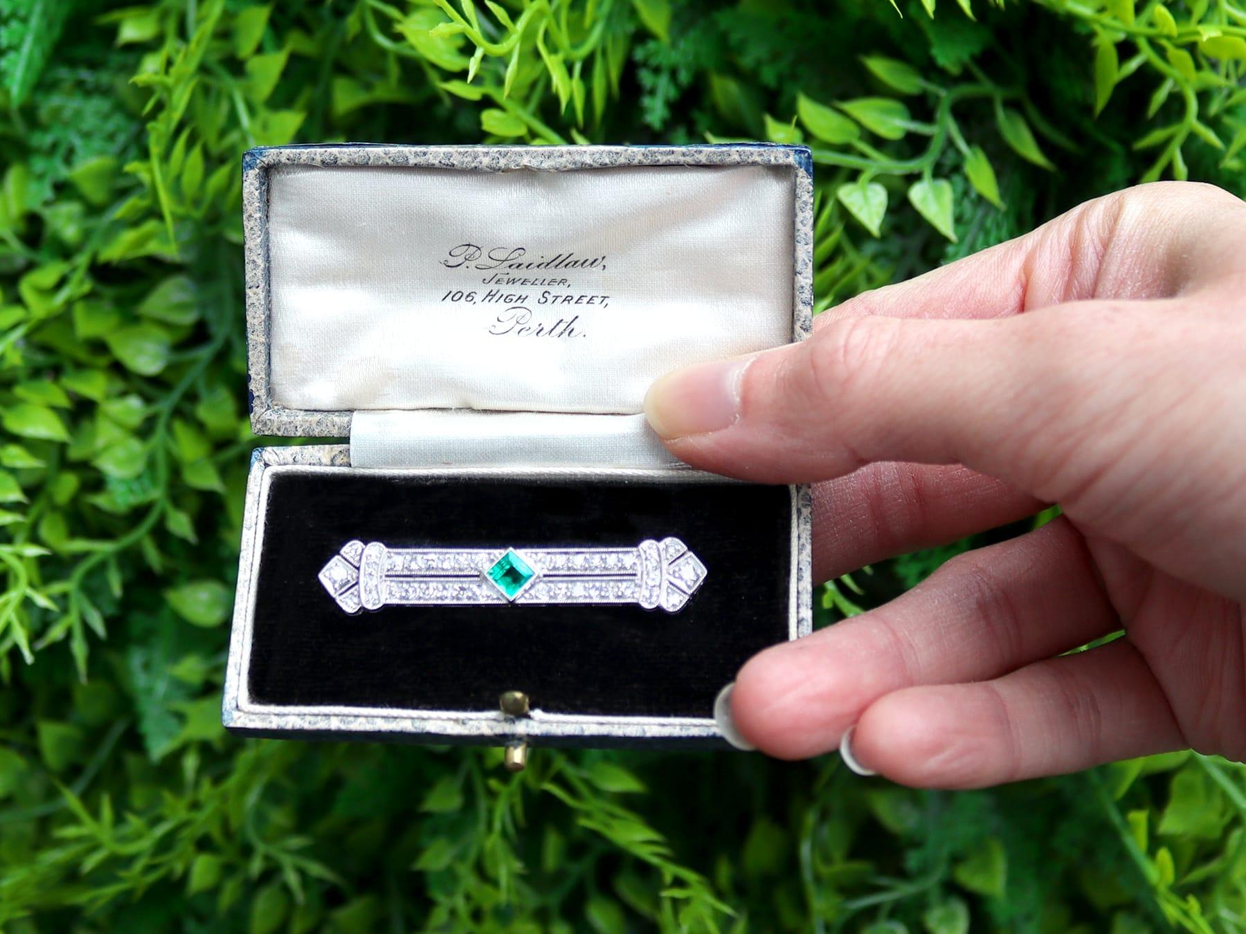 A stunning, fine and impressive antique Art Deco style 0.48 carat emerald and 1.29 carat diamond, platinum brooch; part of our antique jewelry and estate jewelry collections.

This stunning antique diamond and emerald brooch has been crafted in