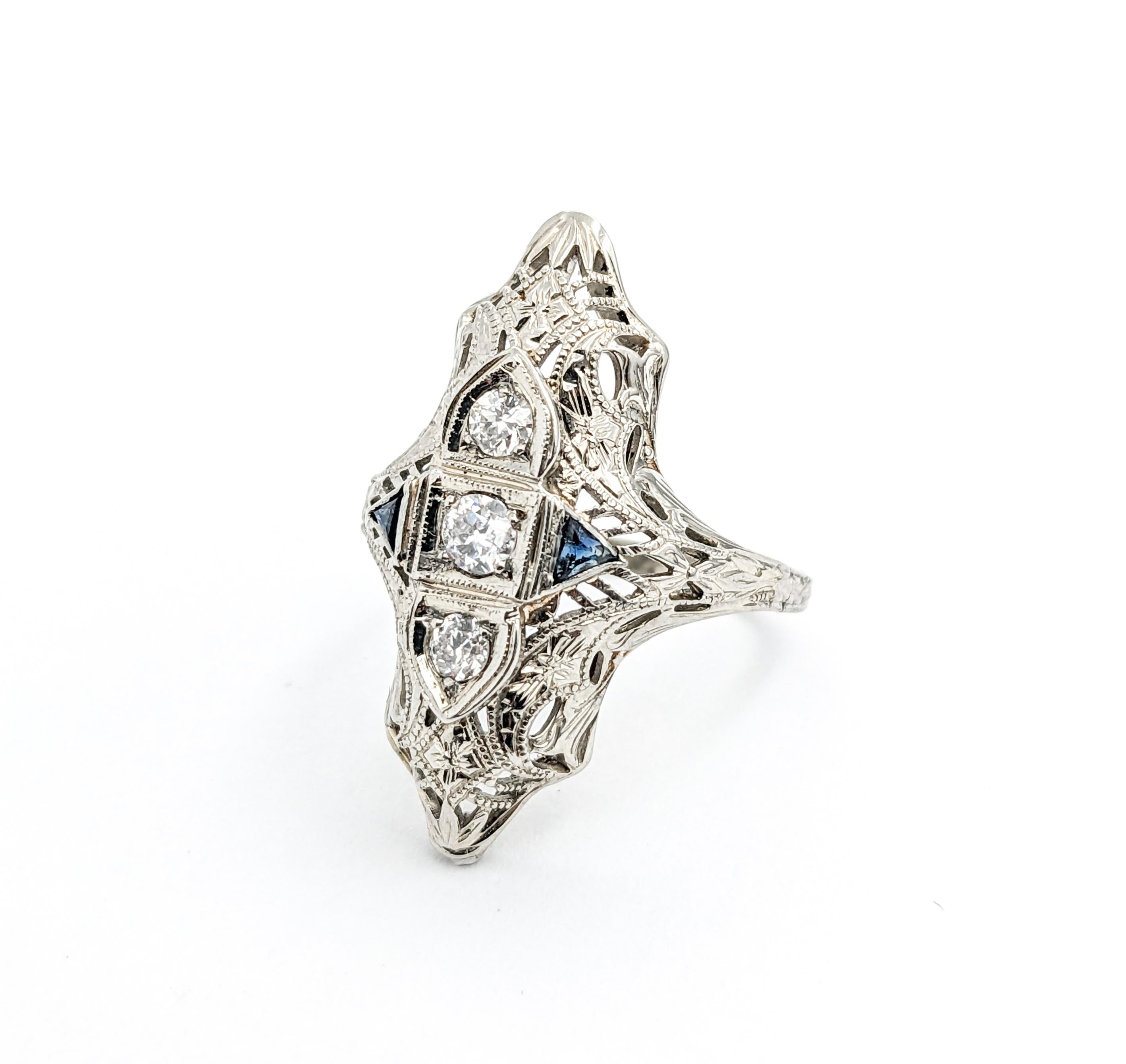 Art Deco era Diamond & Sapphire Ring In White Gold

Presenting a magnificent Antique Ring, exquisitely crafted in 18k white gold. This ring is an embodiment of the elegance and sophisticated design that is characteristic of the Art Deco period. The