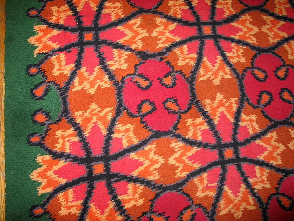 From the post-WWII modernist period, this French pile carpet in good condition shows a complex geometric all-over textile pattern of interlocking circles and small orange-rust fat quatrefoils, along with jagged yellow stars. At least two distinct