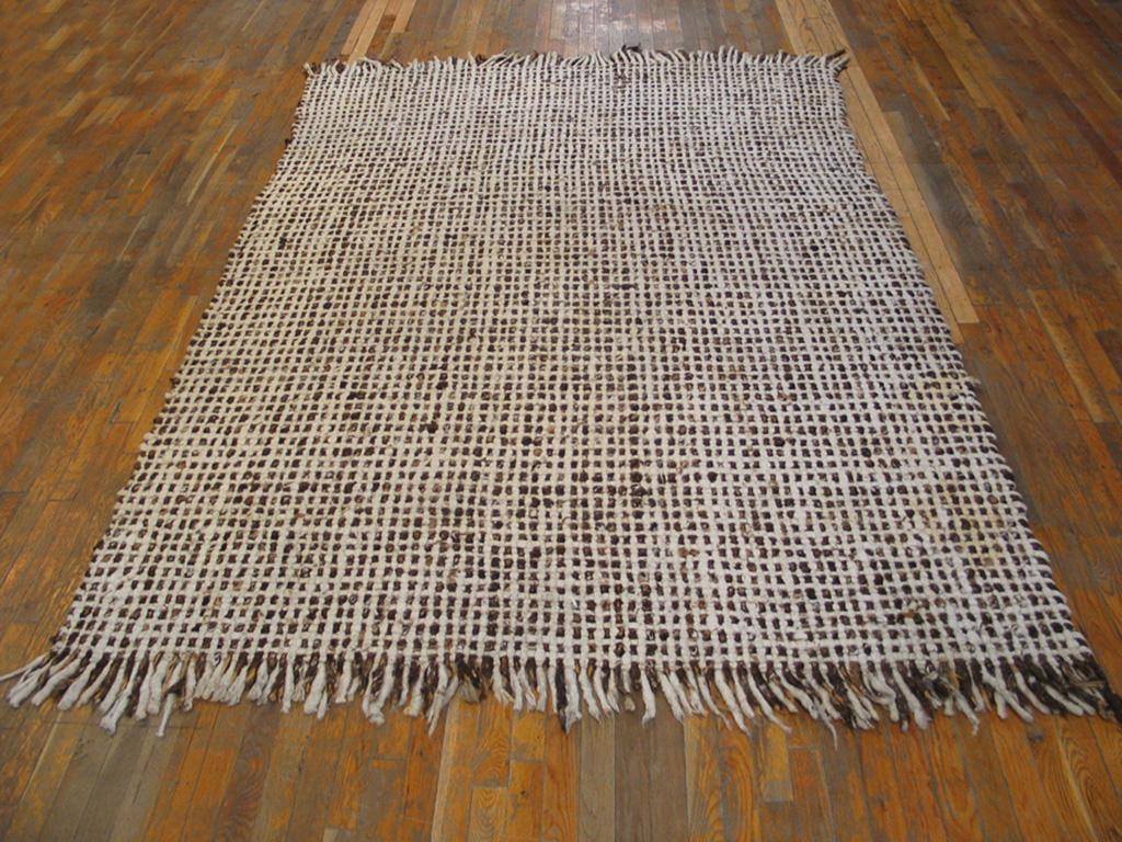A border less, clearly artisanal ecru close rectangular grid work shows tufts and bits in autumnal shades and totally decorates this 1960s German small carpet. Could be recent or just made. Versatile size and period correct with any decor from
