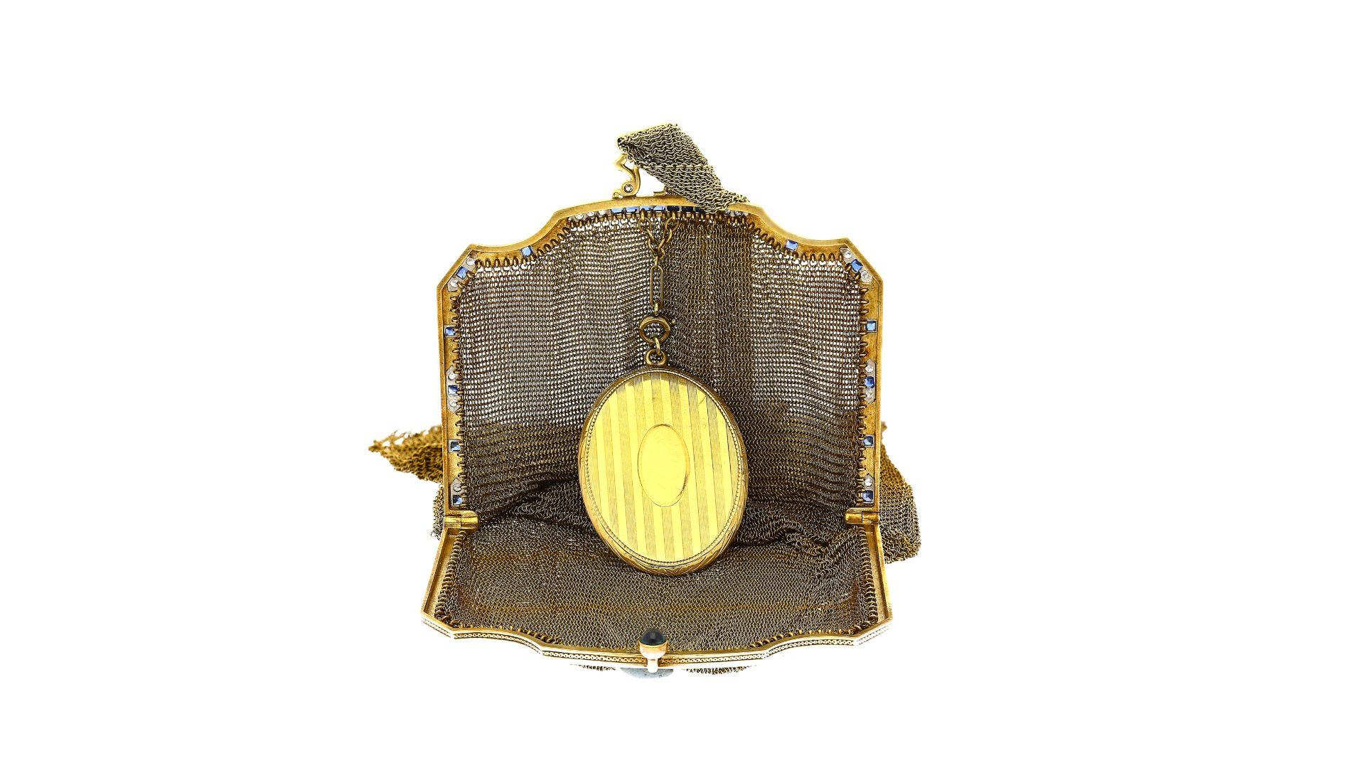 Step into the opulent embrace of yesteryears with an antique Art Deco evening bag that resonates with vintage allure. A true relic, this piece seamlessly melds platinum and 14k yellow gold, evoking an era when craftsmanship was revered. Blue
