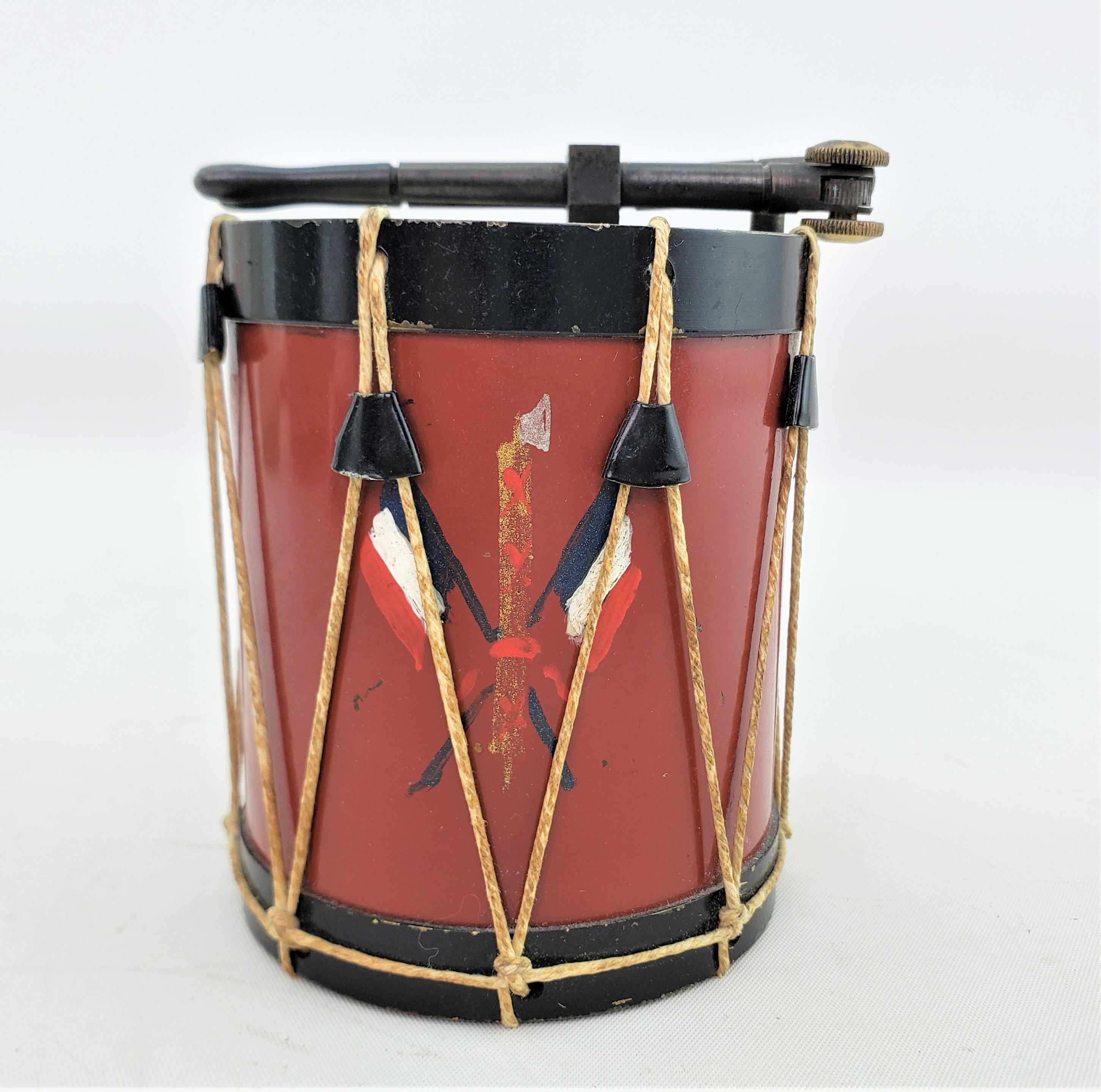This antique table lighter is unsigned, but presumed to have originated from France and date to approximately 1920 and done in the period Art Deco style. The lighter is done in a realistic manner and resembles a marching band drum with two drum