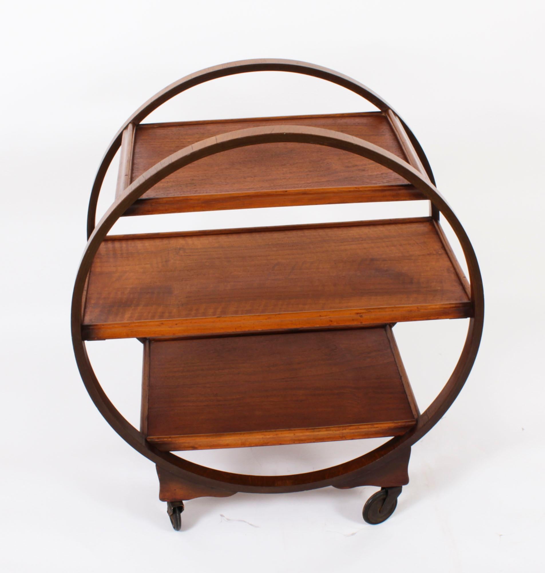 This is a striking antique Art Deco  three-tier figured walnut hostess trolley dating from the 1920s.

The trolley is of decorative circular form and is fitted with castors.

This is a very entertaining serving trolley which can also be used as a