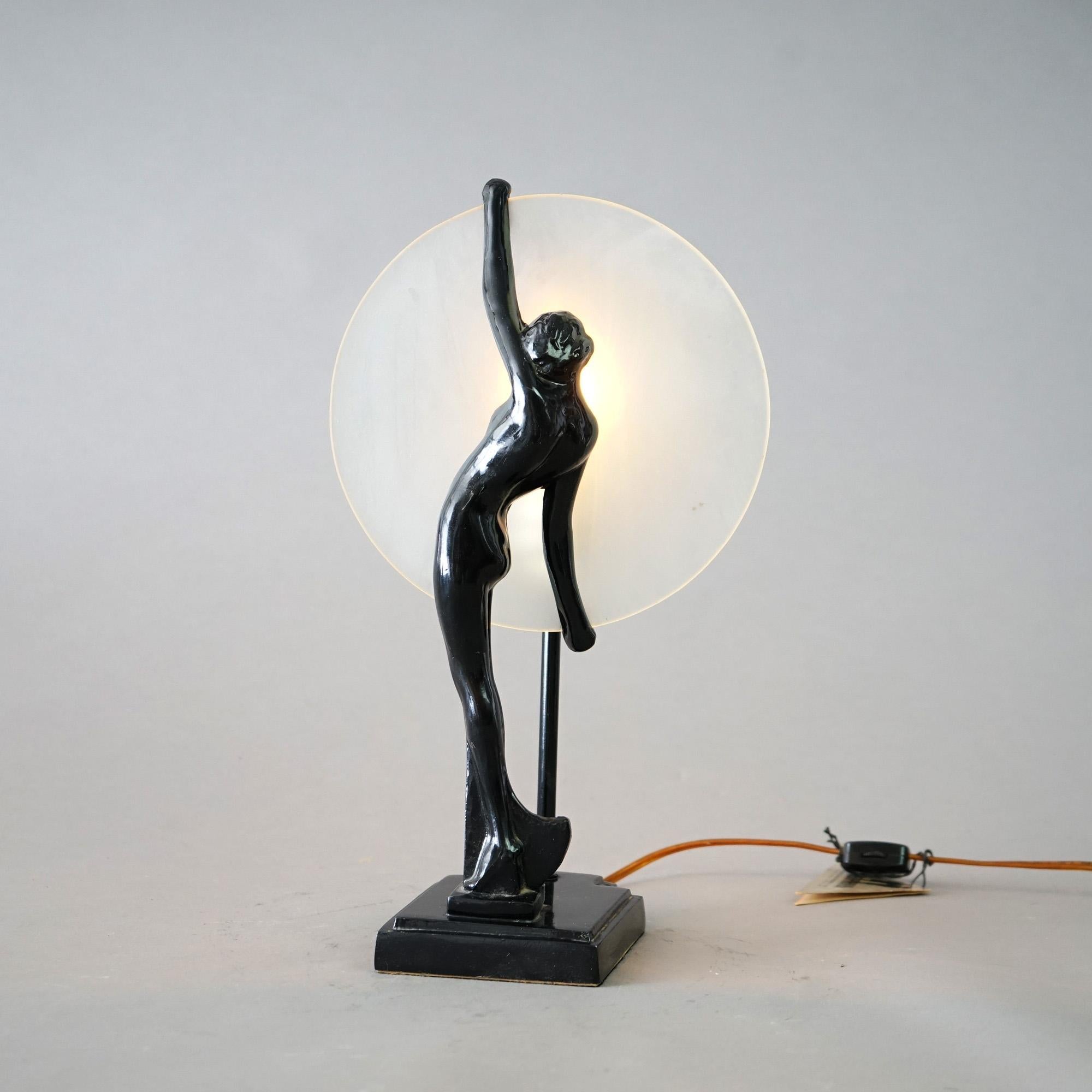 An antique Art Deco sculptural table lamp by Sarsaparilla in the manner of Frankart offers figural standing woman raising the moon, maker tag as photographed,  20th century

Measures - 14.5