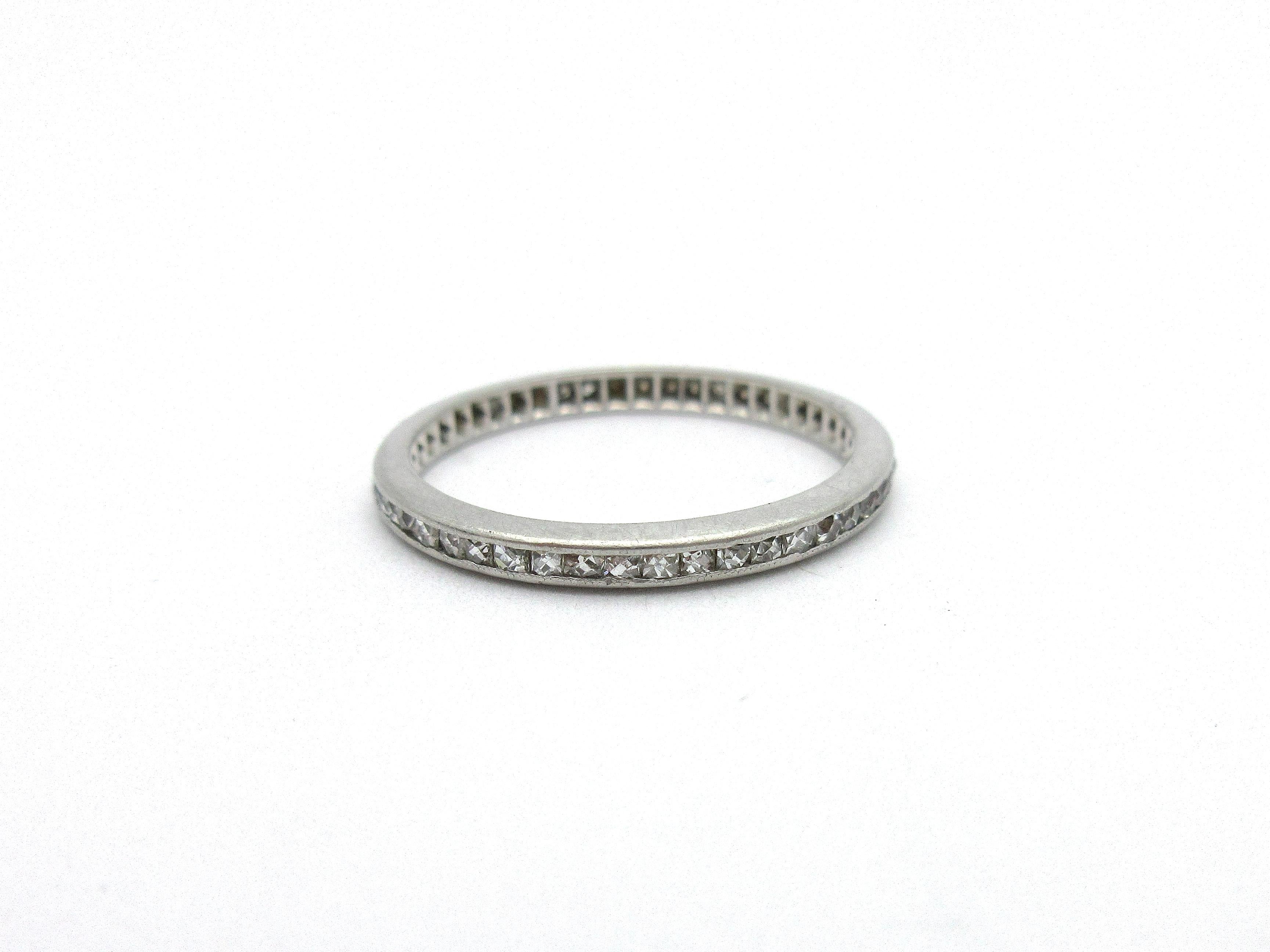 This gorgeous antique eternity band from the Art Deco era is a true rarity, perfect for stacking! The platinum band boasts channel-set french cut diamonds that extend all the way around, totaling approximately .65cttw. The diamonds are graded H in