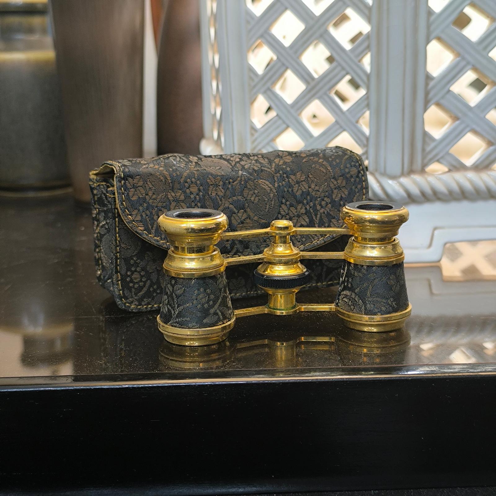 Vintage Theater Nixen Binoculars - A Luxurious Item for Theater Enthusiasts
•	Marked: NIXEN PARIS
•	Color: Gold tone with black and gold tone floral fabric
•	Dimensions: Measures 3 3/8