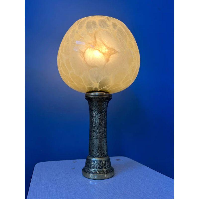 Art nouveau table lamp with golden base and glass shade. The lamp requires one E14 lightbulb and currently has an EU-plug.

Dimensions:
ø Shades: 14 cm
Height: 24 cm

Condition: Good. The base is an excellent shape, the glass shade has three