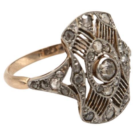 Former original Art Deco ring from around 1925.

Geometric, symmetrical shapes characteristic of the Art Deco style.

Openwork, hand-made structure made of yellow 18-carat gold with platinum elements.

Ring set with old-cut diamonds - central