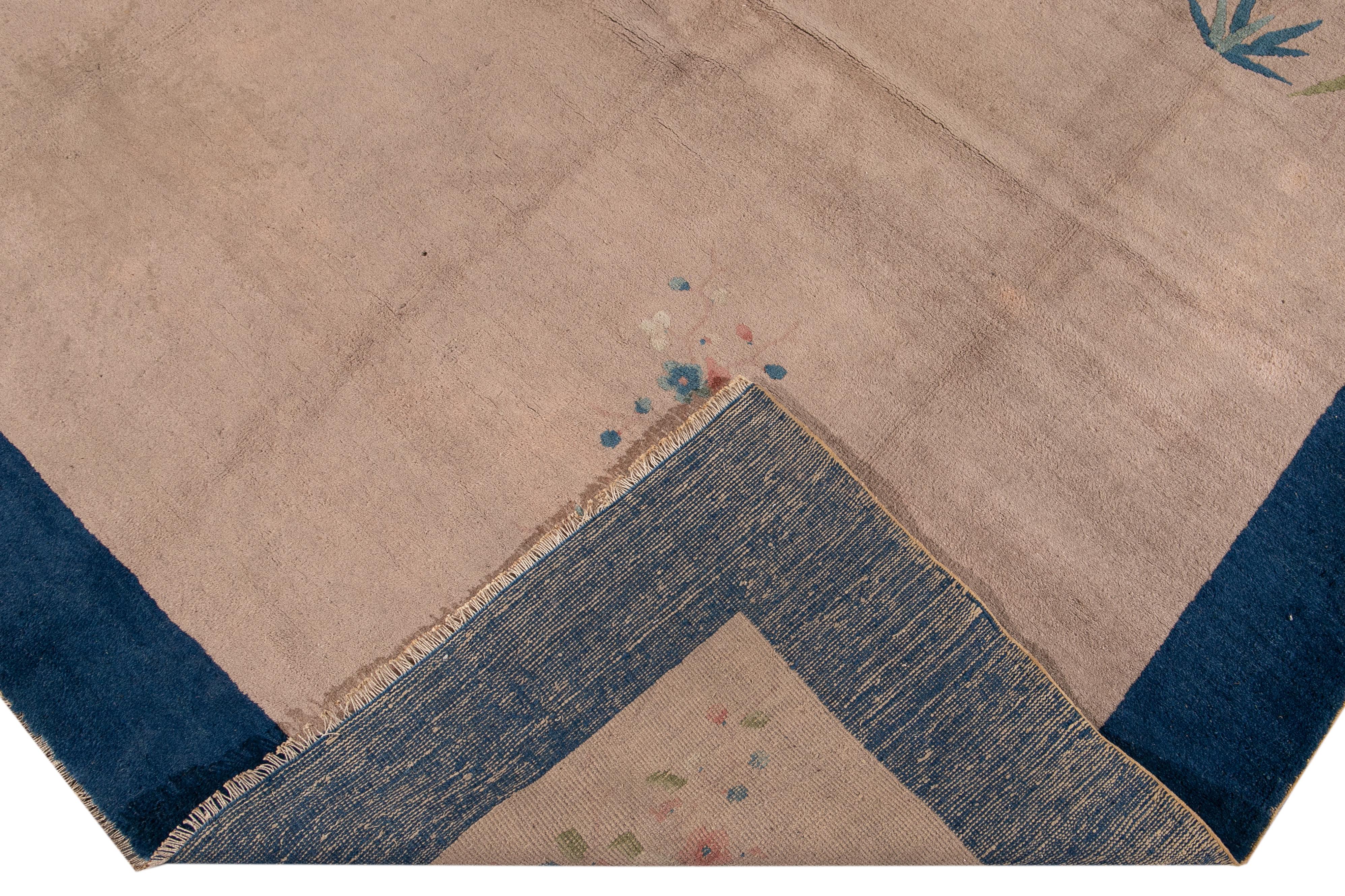 A beautiful antique Art Deco Chinese hand-knotted wool rug with a peach field. This rug has a blue frame, green, peach, and ivory accents in a gorgeous Chinese floral design.

This rug measures: 7'9