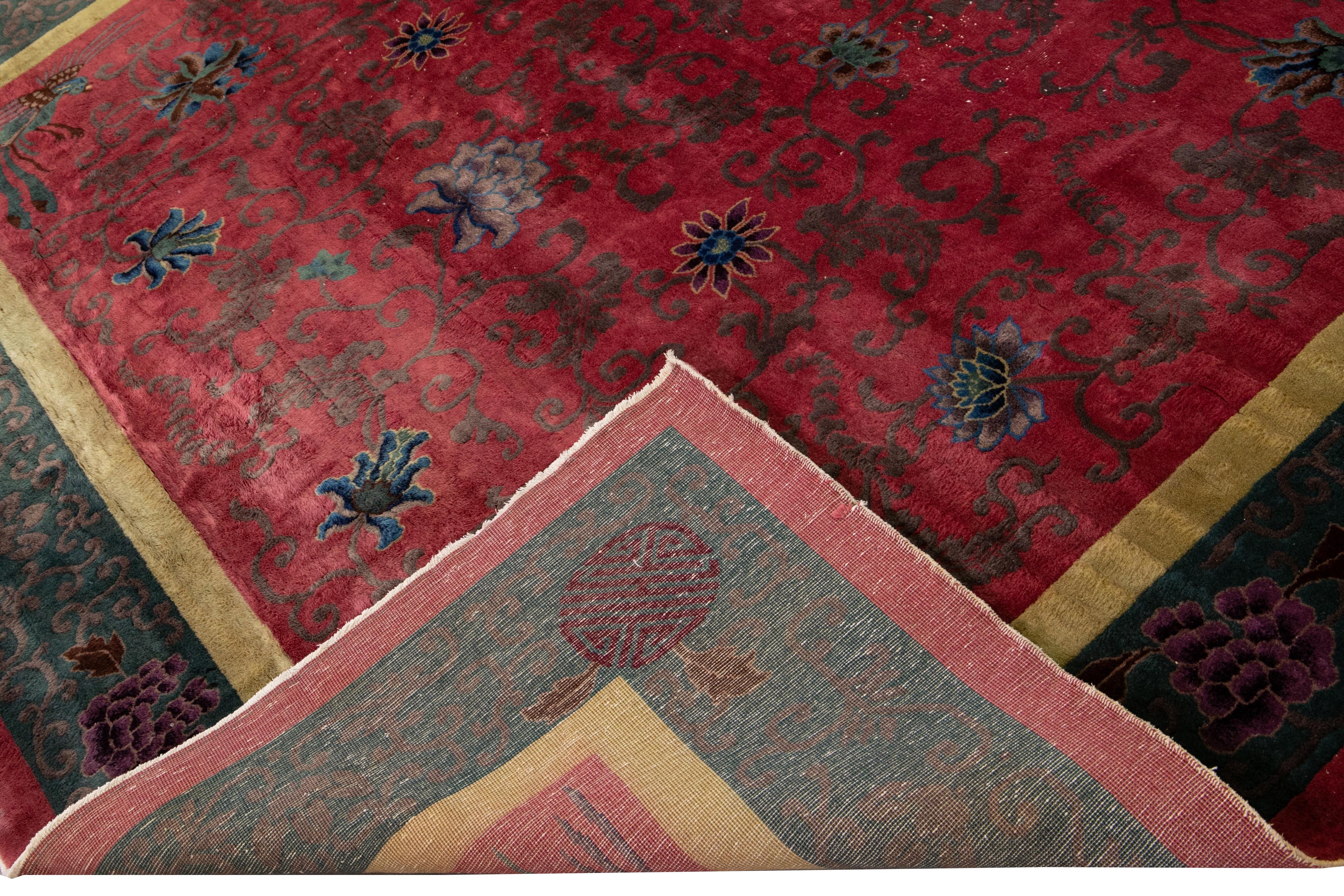 Beautiful antique Art Deco Chinese hand-knotted wool rug with a red field. This Chinese rug has a green and yellow frame multi-color accents in a gorgeous all-over traditional Chinese floral design. 

This rug measures: 10' x 17'5