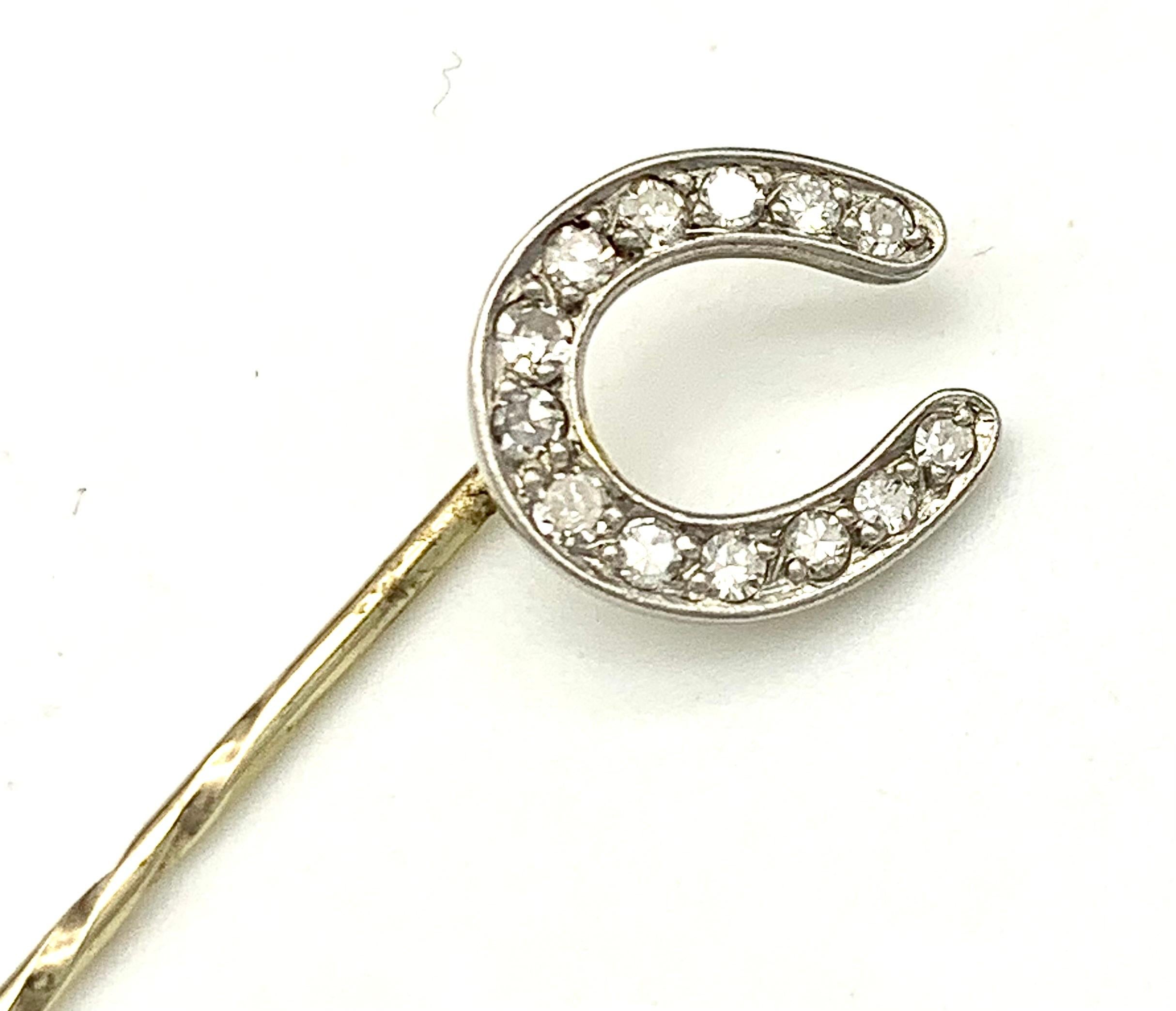 This elegant horseshoe stickpin promises good luck to its wearer, understated elegance thanks to the delicate design, executed in platinum and set with diamonds.  The pin is made out of 14 karat yellow gold.  