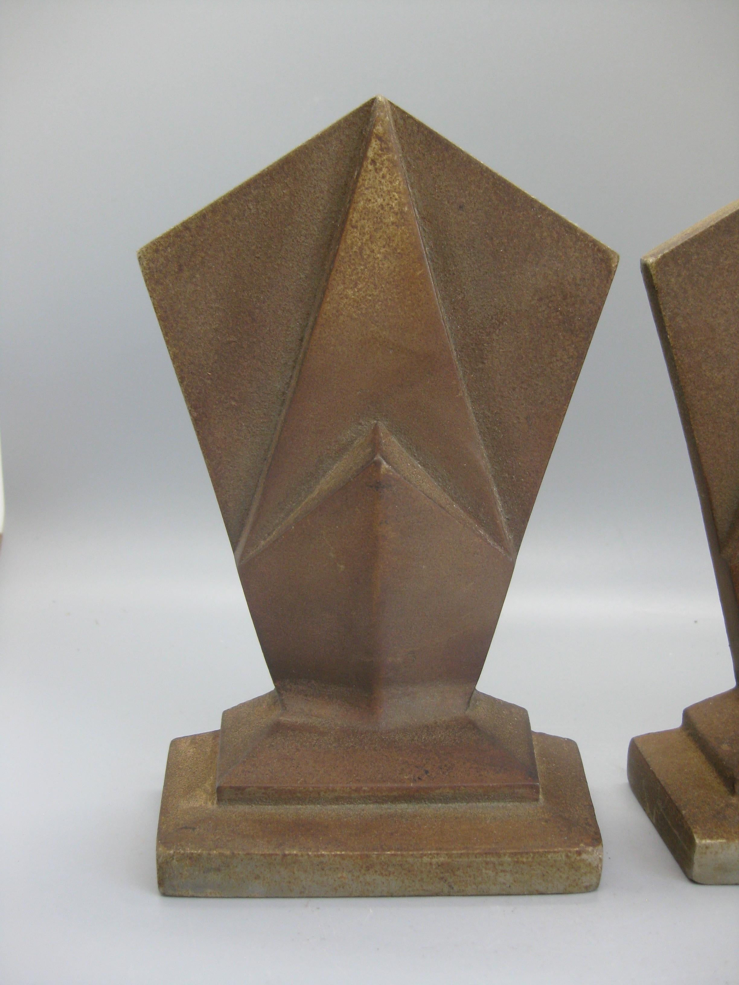 Great pair of antique Art Deco Hubley model #307 cast iron geometric skyscraper bookends and date from the 1920s-early 1930s. These are made of cast iron and have a nice old patina. Great details and design. Signed on the back. In nice original