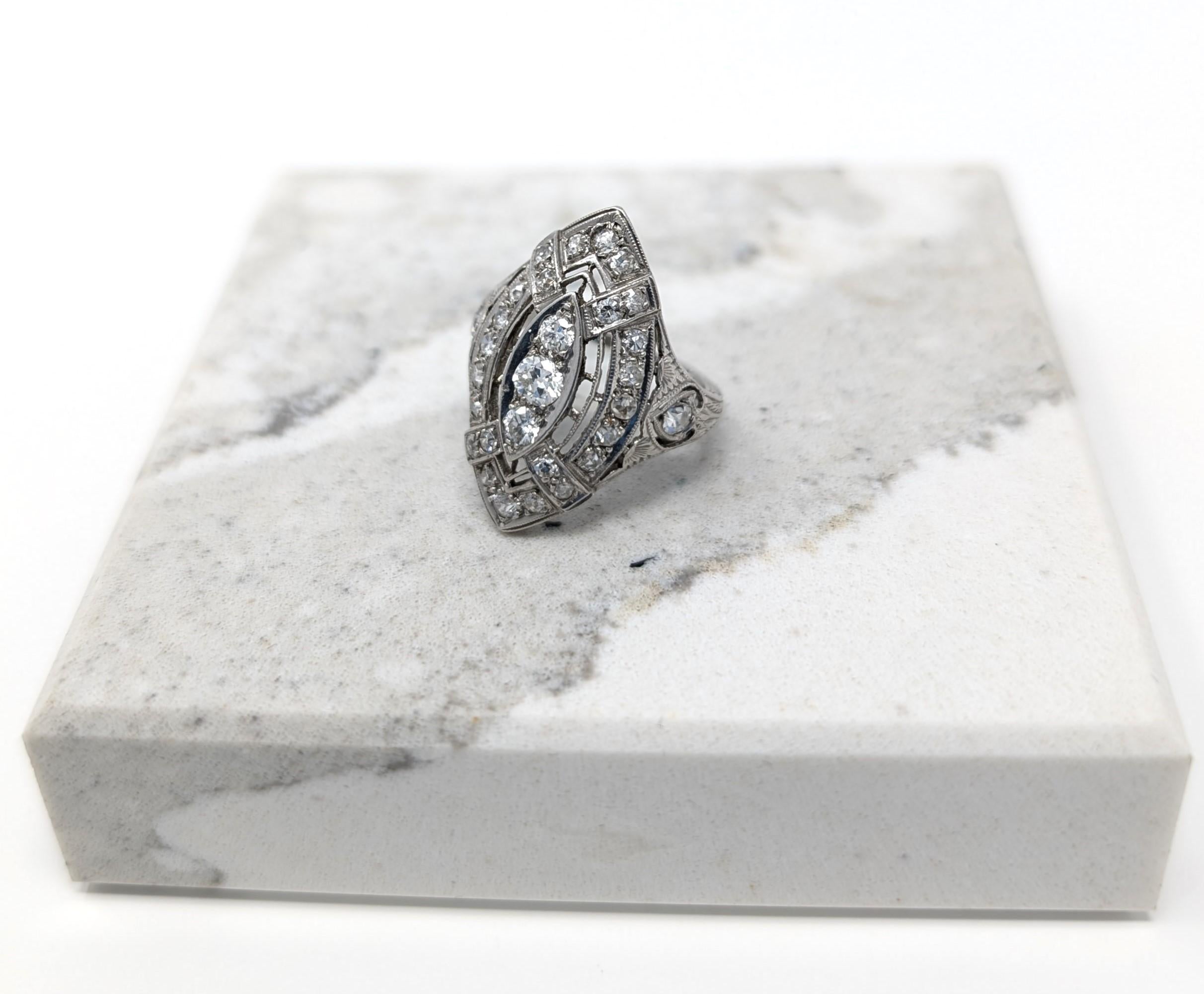 Stunning antique art deco irid platinum and diamond ring, filigree in design with a navette shape. This dazzling ring is the epitome of 1920's and 1930's elegance! An eye catching work of art, measures .98 inch at its tallest points by 1.5mm at its
