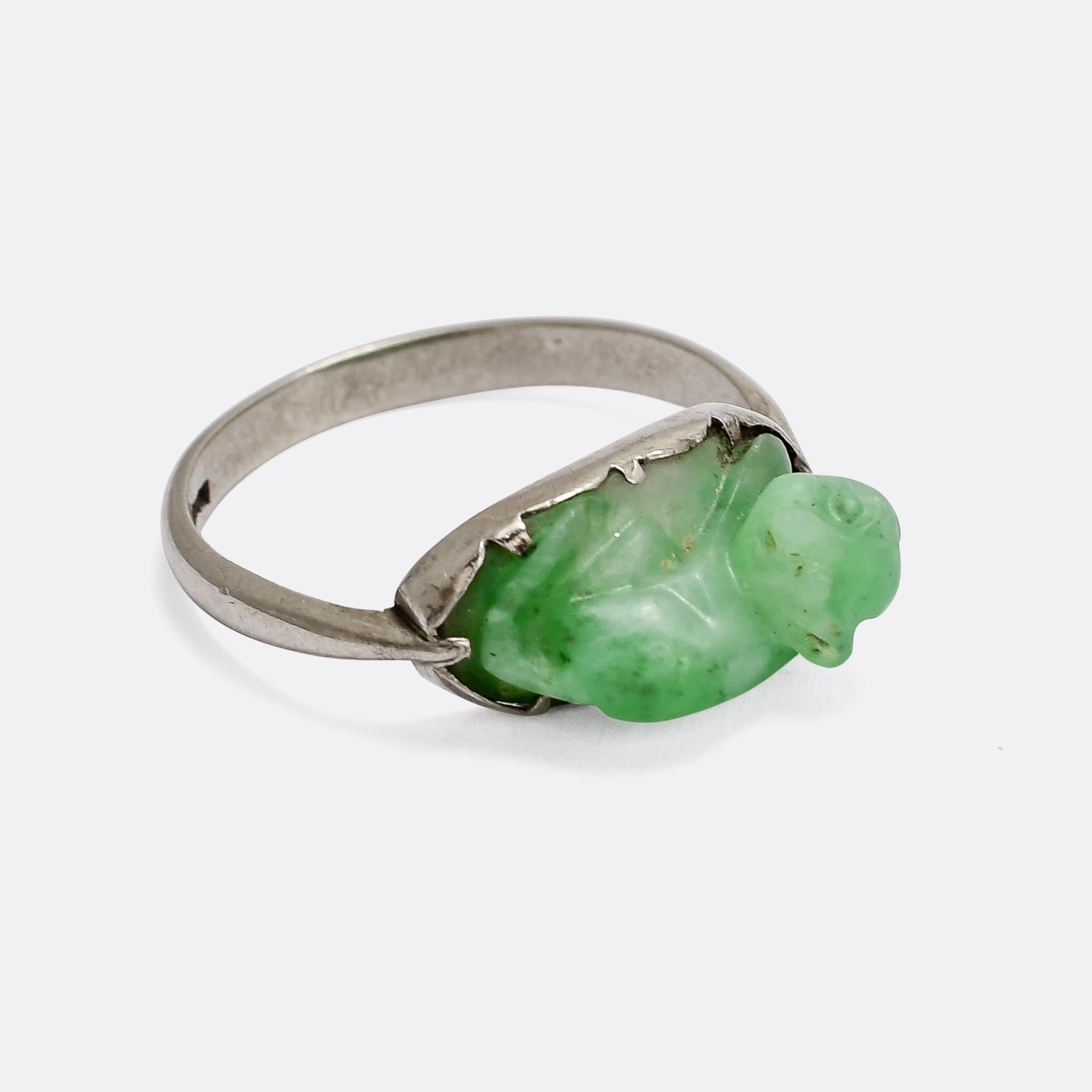 A very unusual antique ring set with a carved jade cat (I think). It could be a monkey, but the body is definitely more cat-like. It's set in an Art Deco period white gold ring mount with elegant pinched shoulders.

STONES 
Carved Jade

RING