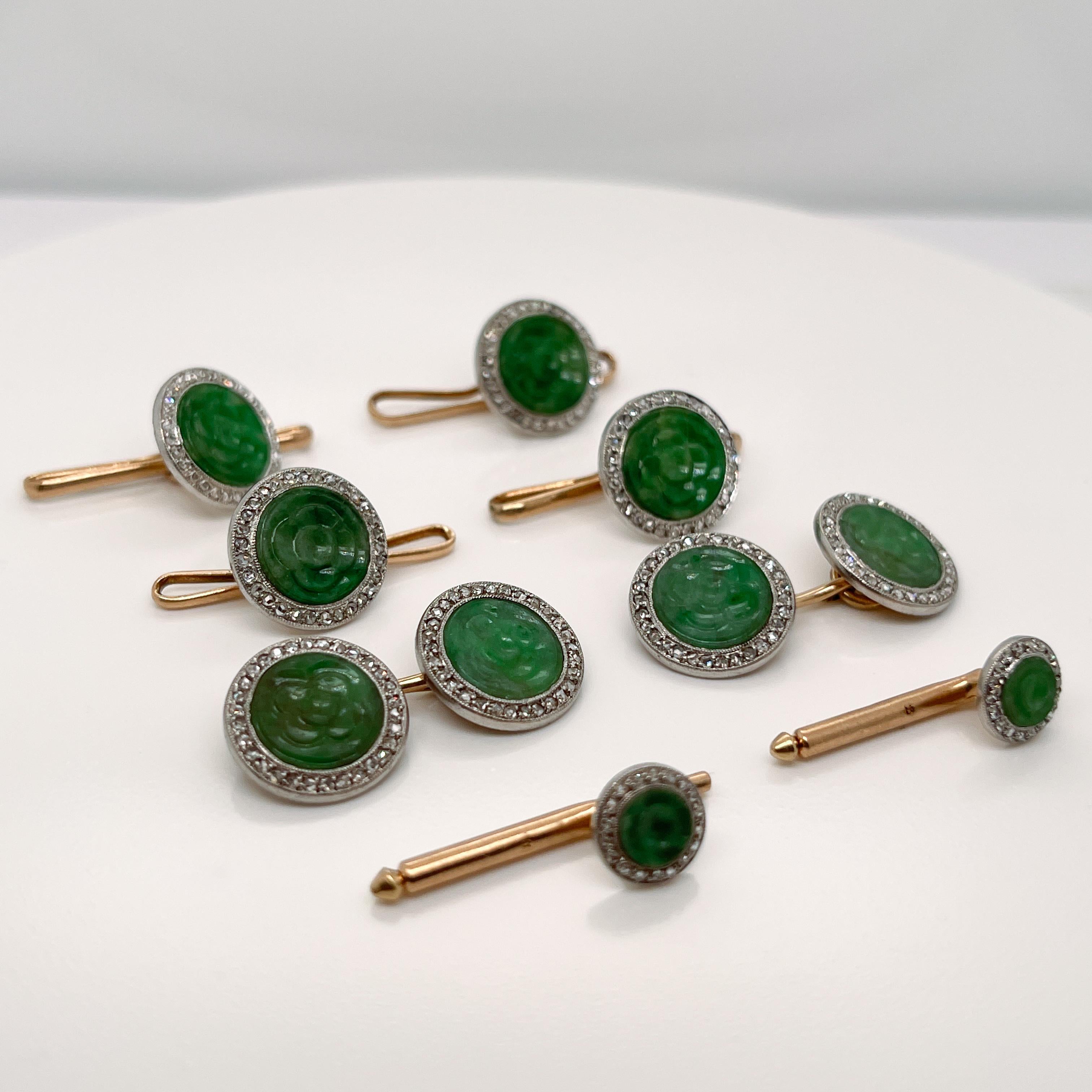 A very fine Art Deco period cufflink and dress set. 

In platinum-topped 14k yellow gold and set with a jade (jadeite) cabochons framed by tiny rose cut diamonds.  

Each flat jade (jadeite) cabochon is carved with a stylized floral device.

The set