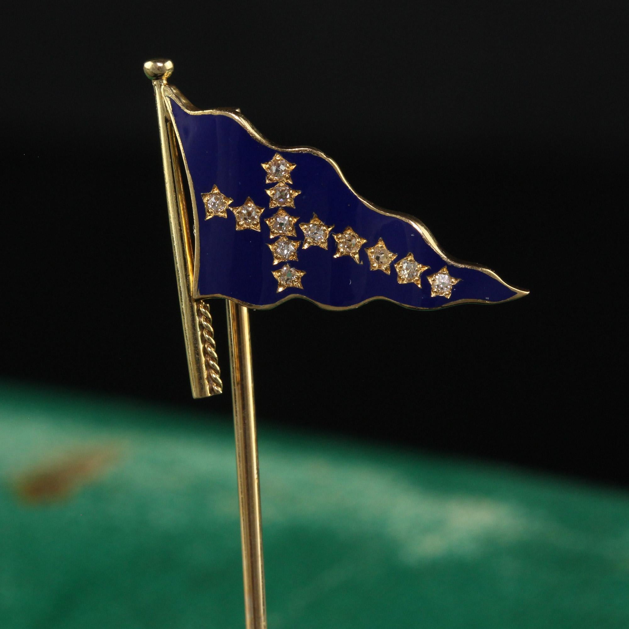Beautiful Antique Art Deco J.E Caldwell Blue Enamel Flag Stick Pin. This gorgeous Caldwell stick pin is crafted in 18K Yellow Gold. The pin features a flag that has blue enamel on it with old cut diamonds forming a sideways cross. We believe this
