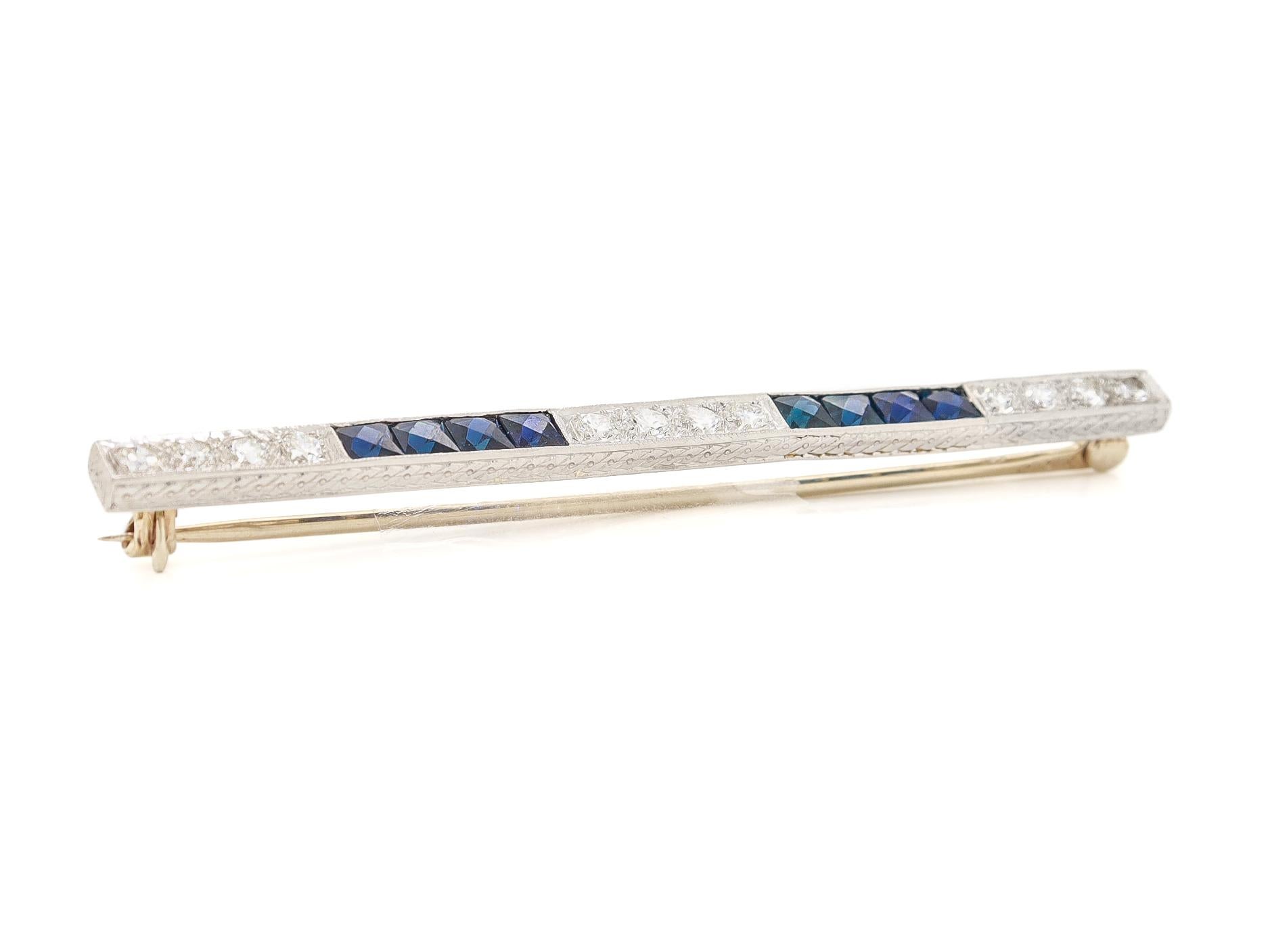 A fine signed Art Deco bar pin or brooch.

In platinum.

By J.E. Caldwell of Philadelphia.

With 8 channel-set rectangular French cut (lab created) sapphires & 12 prong-set transitional round brilliant diamonds.

The platinum mount with engraved