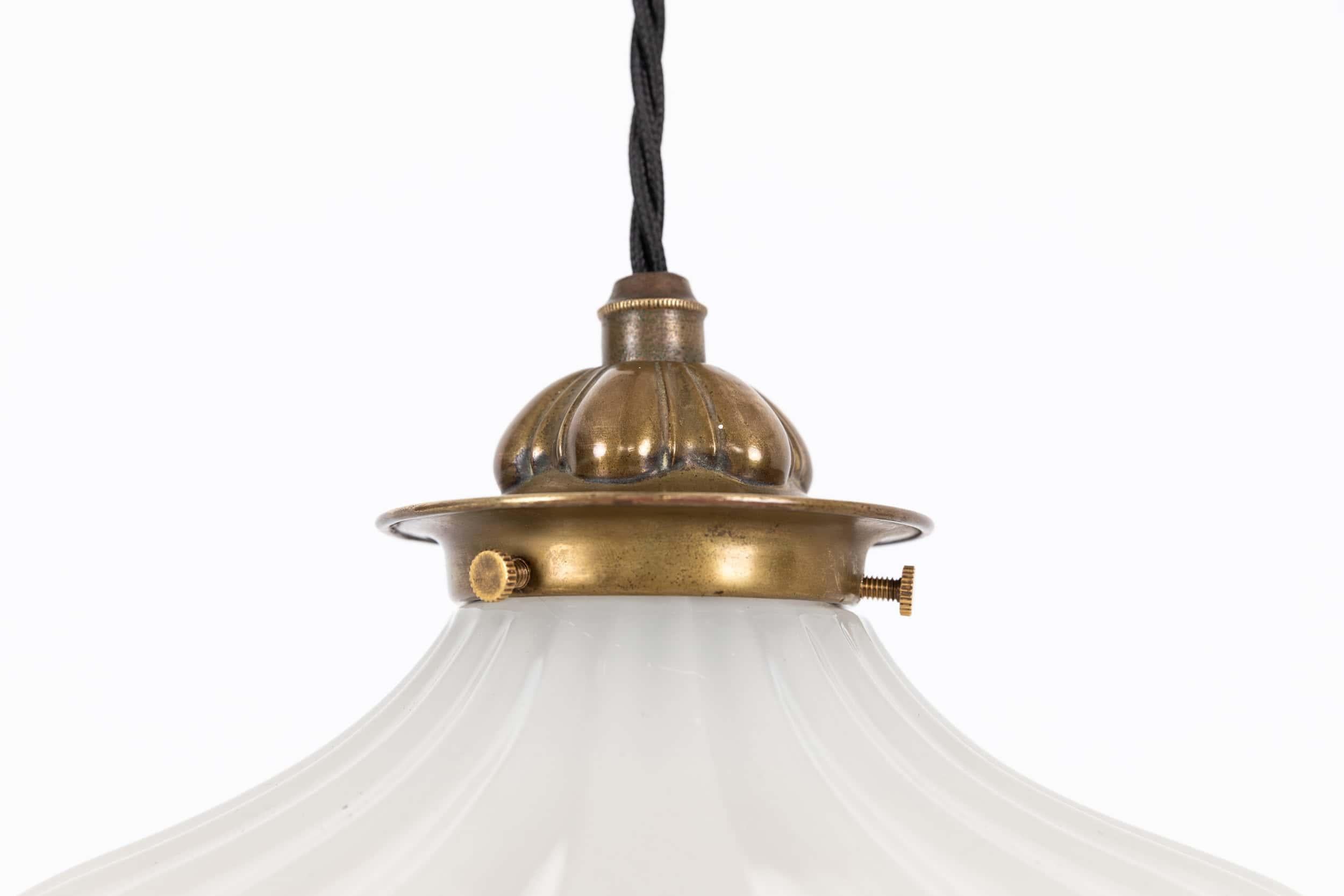 

An elegant opaline moonstone glass 'Doric' pendant light. c.1930

Flared, low-profile, thick pressed moonstone glass shade of fluted design with original GEC brass gallery
