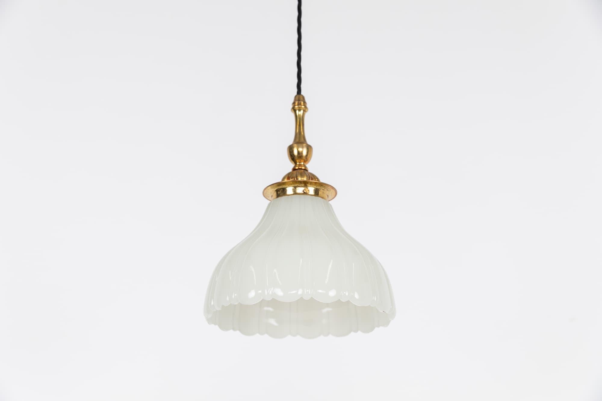 

An incredibly elegant single moonstone pendant lamp with brass cord gripped gallery. c.1930

Thick pressed moonstone glass of fluted design with original elongated brass GEC gallery. Small chip to inside.

Rewired with black twisted flex.
