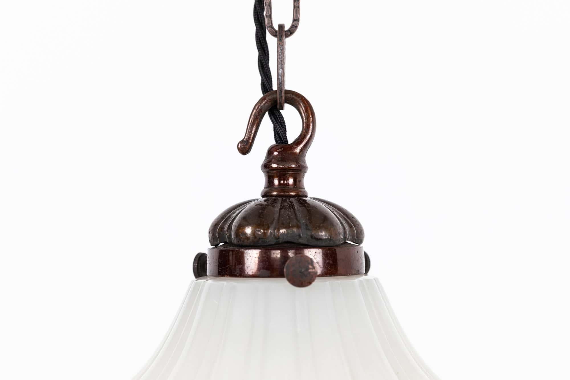 

An elegant moonstone pendant lamp with brass gallery. c.1930

Thick pressed moonstone glass of fluted design with original brass GEC gallery.

Rewired with black twisted flex.
